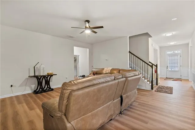 a living room with furniture a rug and a flat screen tv