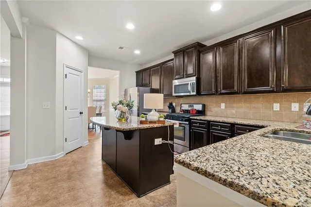 a spacious bathroom with a double vanity sink a mirror and a bathtub