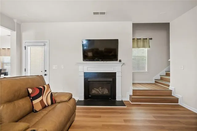 a kitchen with kitchen island stainless steel appliances a sink stove refrigerator and cabinets