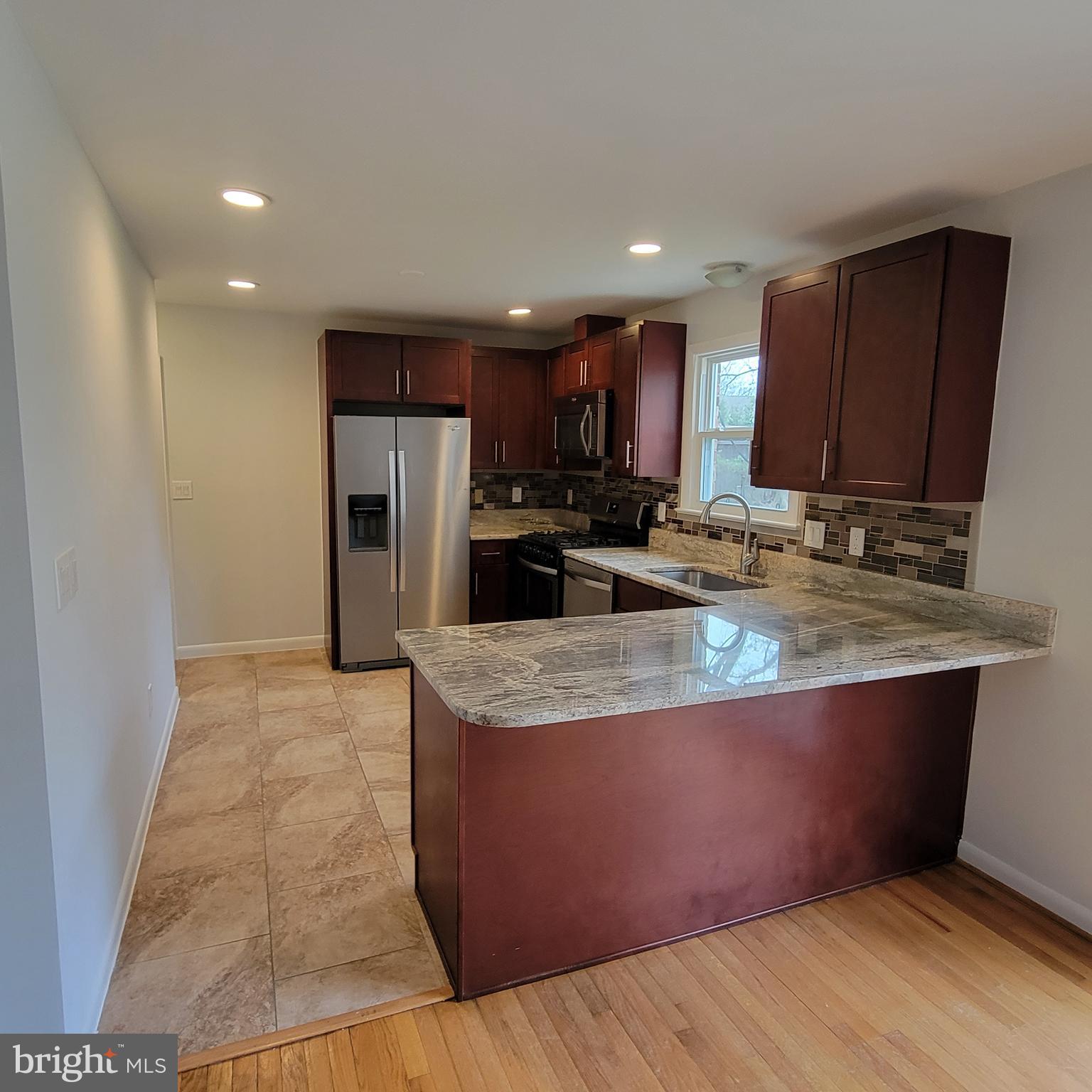 18320 Metz Drive Germantown, MD 20874 - Photo 2 of 31 a kitchen with stainless steel appliances granite countertop a sink a stove a refrigerator a microwave a counter space and cabinets