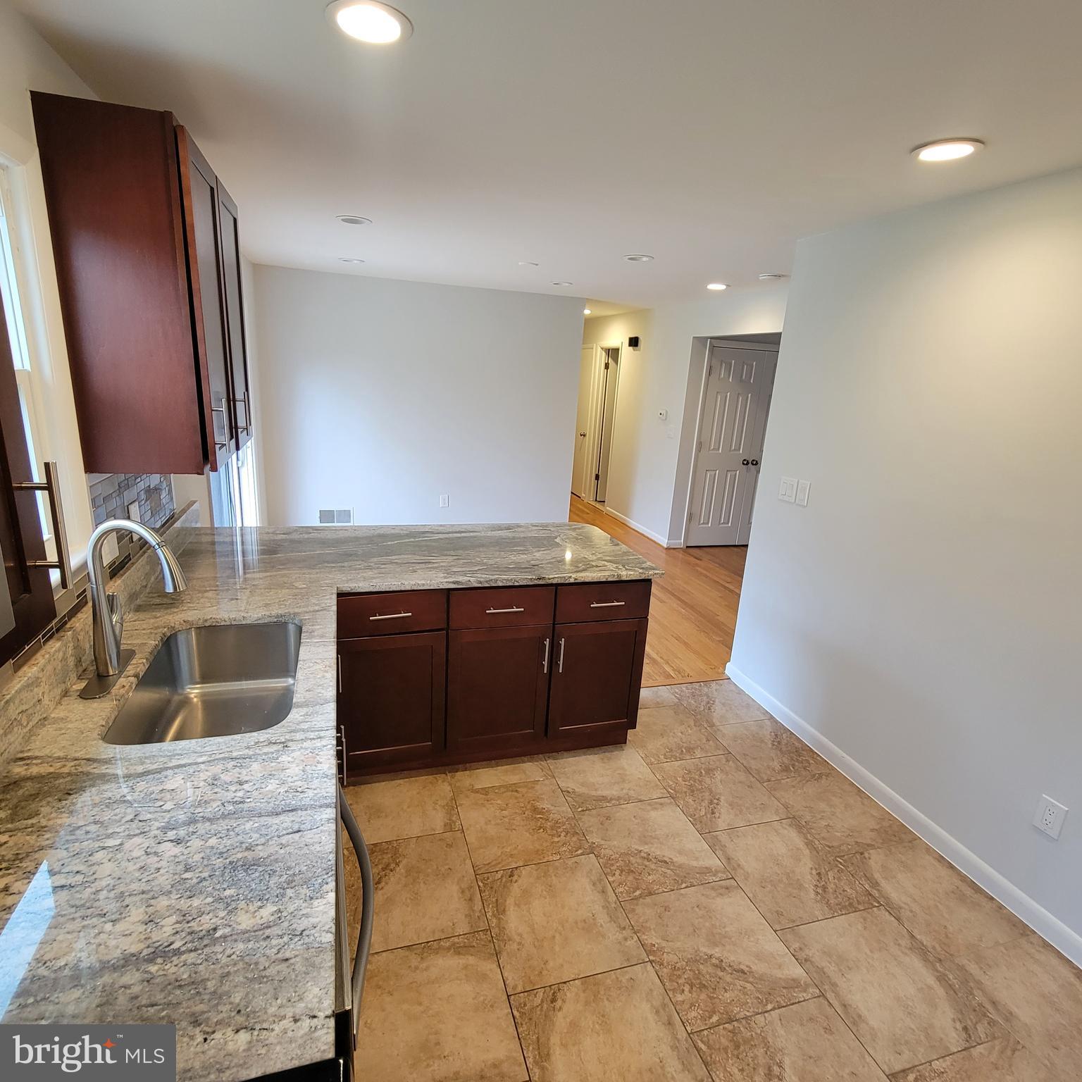 18320 Metz Drive Germantown, MD 20874 - Photo 4 of 31 a spacious bathroom with a granite countertop sink and a mirror