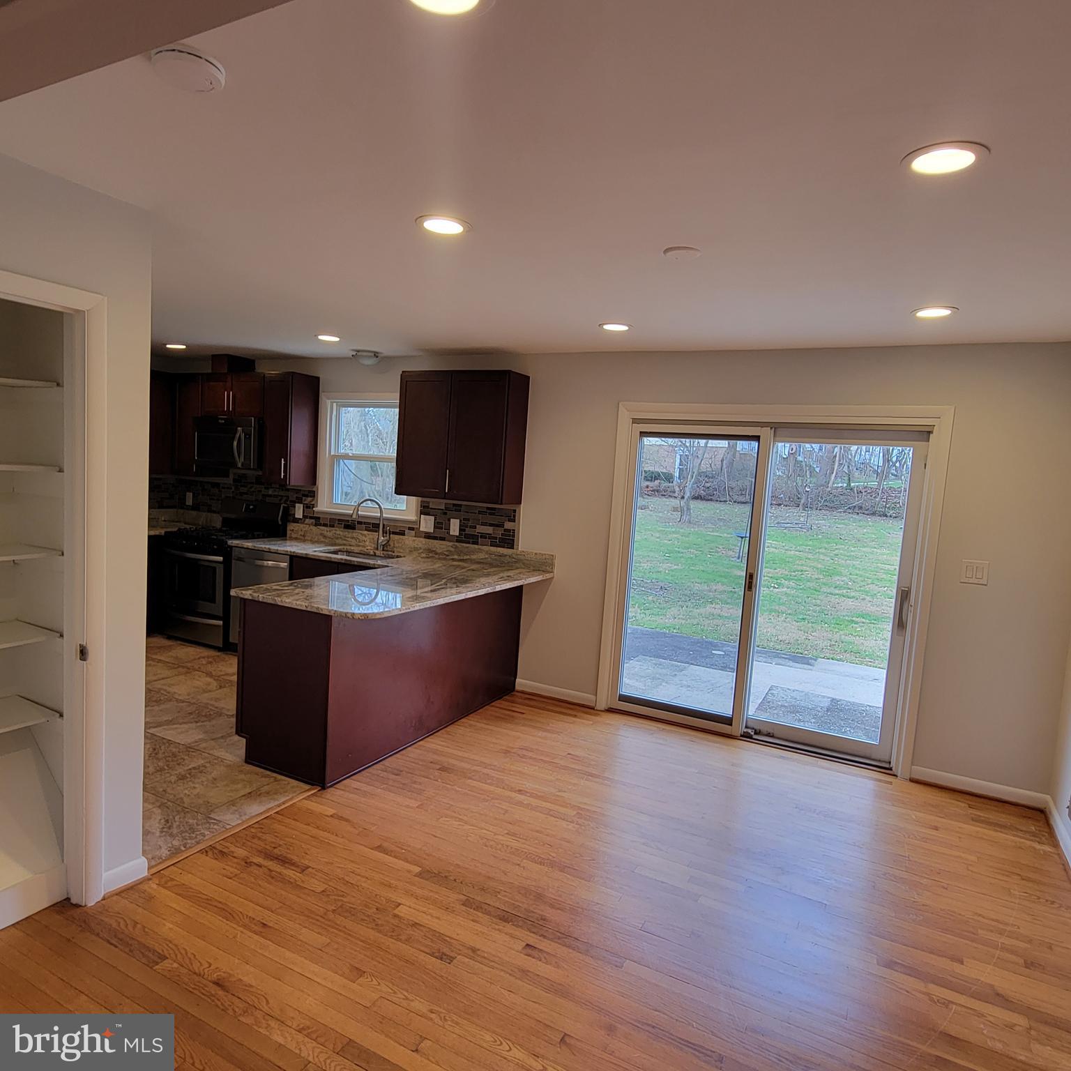 18320 Metz Drive Germantown, MD 20874 - Photo 7 of 31 a kitchen with stainless steel appliances granite countertop a stove a sink and a refrigerator