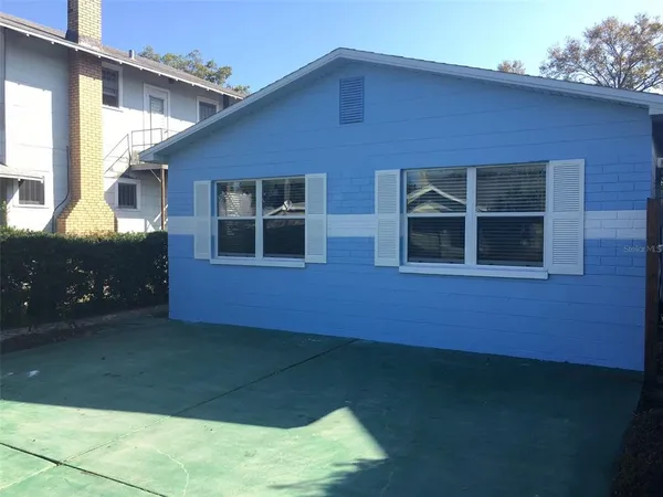 a backyard of a house with large window