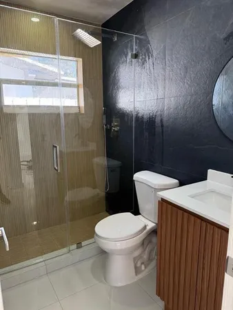 a white toilet sitting next to a bathroom sink