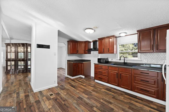 a kitchen with stainless steel appliances granite countertop a refrigerator sink and cabinets