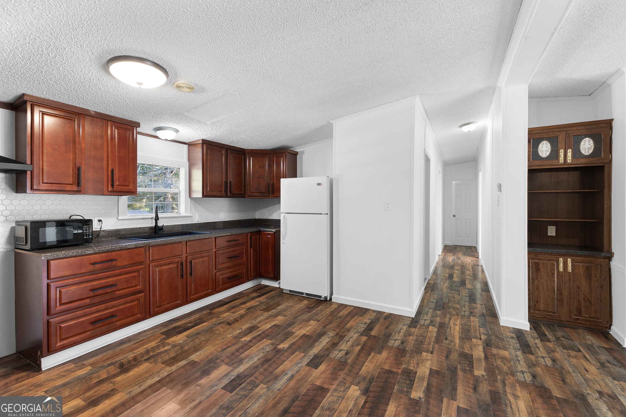 4653 Whispering Pines, Unit 449 Buford, GA 30518 - Photo 12 of 33 a kitchen with stainless steel appliances granite countertop a refrigerator and a stove top oven