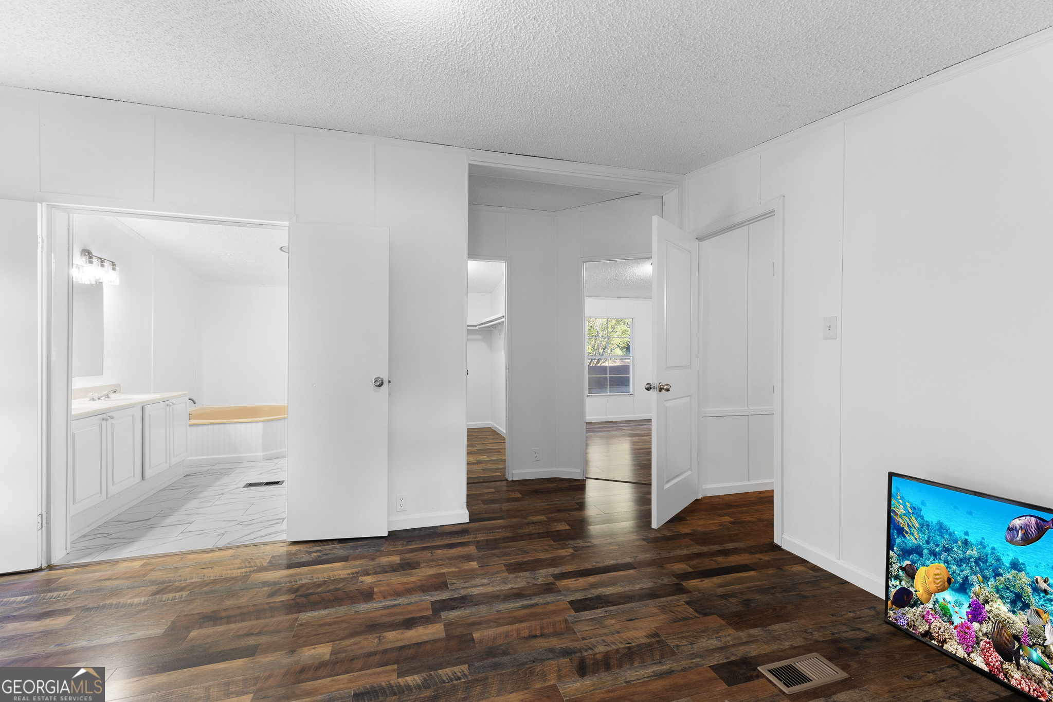 4653 Whispering Pines, Unit 449 Buford, GA 30518 - Photo 14 of 33 a view of a room with wooden floor and furniture