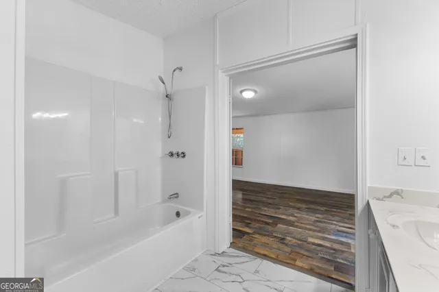 a bathroom with a bathtub and a shower