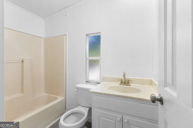 a bathroom with a sink toilet and bathtub