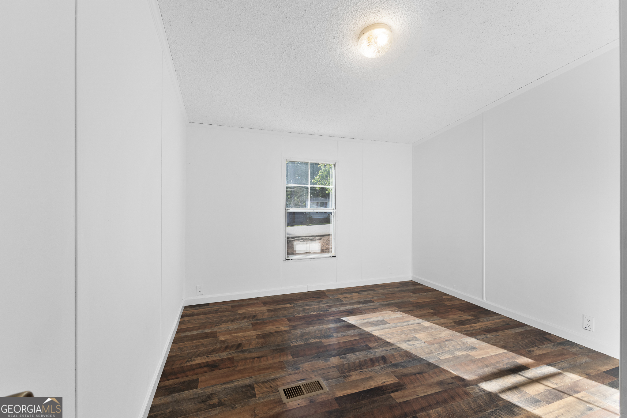 4653 Whispering Pines, Unit 449 Buford, GA 30518 - Photo 25 of 33 a view of empty room with wooden floor
