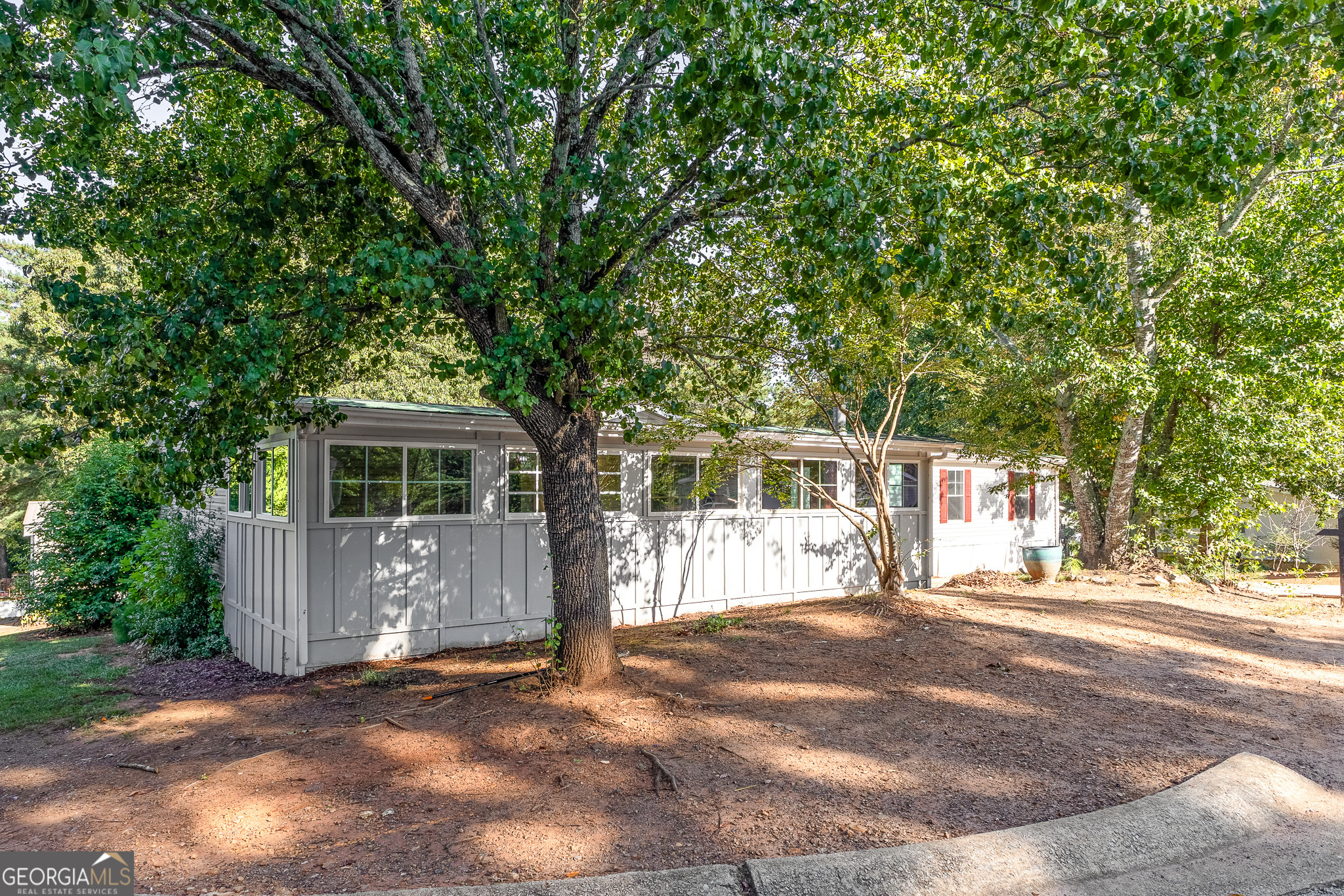 4653 Whispering Pines, Unit 449 Buford, GA 30518 - Photo 4 of 33 a front view of a house with a garden