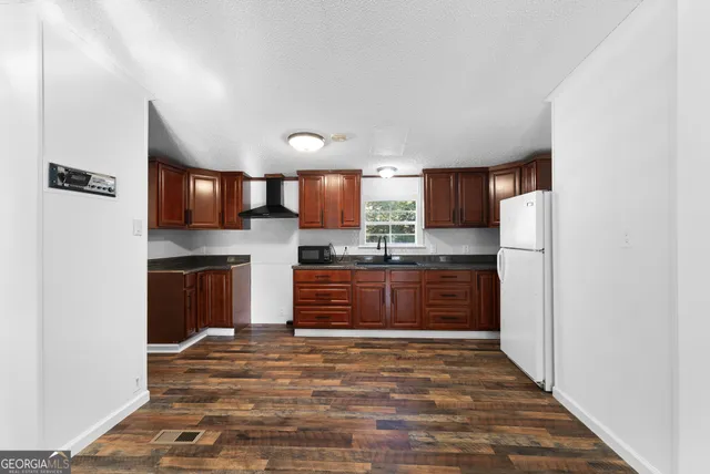 a kitchen with stainless steel appliances granite countertop a refrigerator and a sink