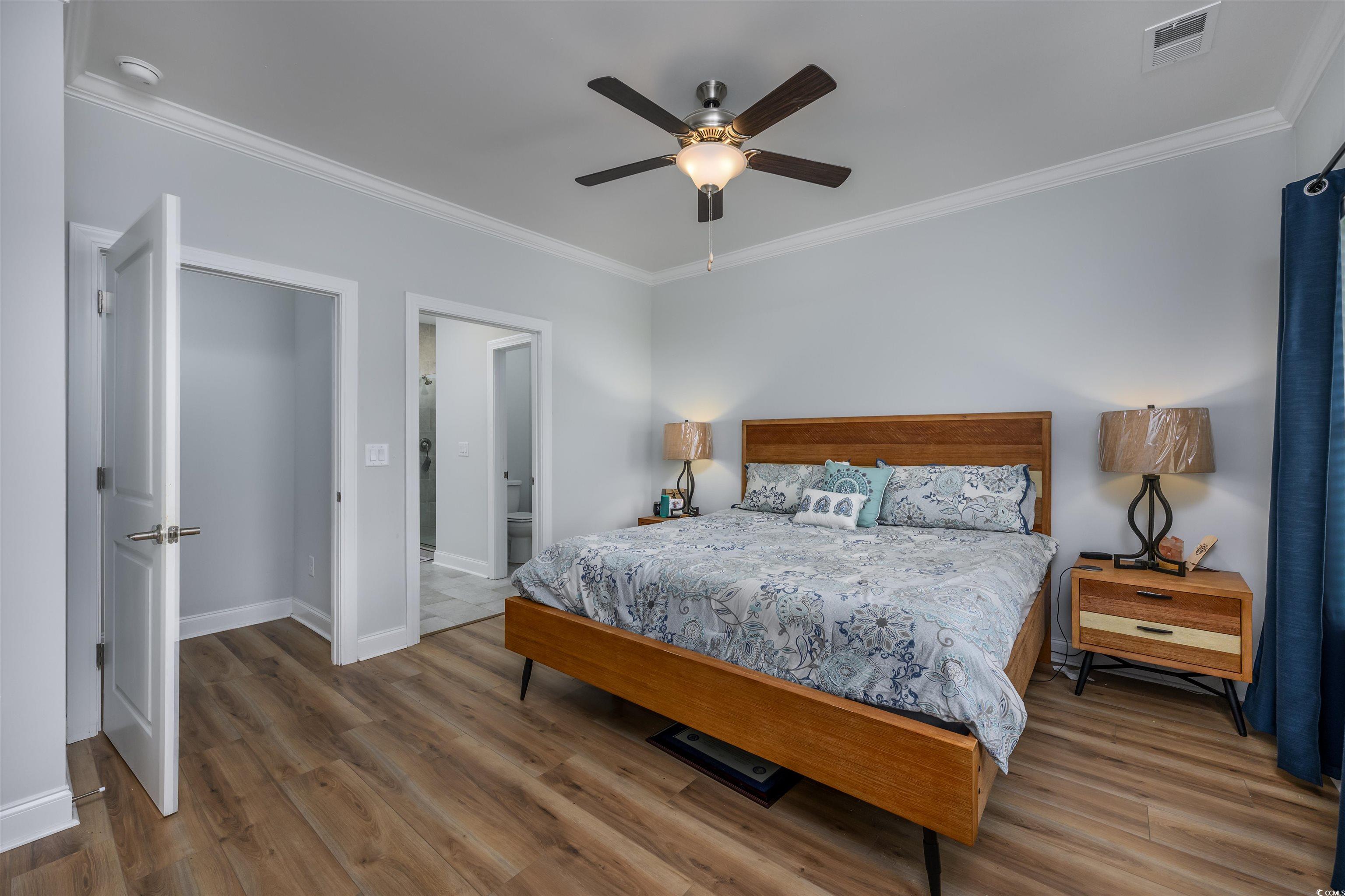 2550 Dogwood Road Longs, SC 29568 - Photo 15 of 35 Bedroom with crown molding, wood finished floors, ensuite bath, and a ceiling fan