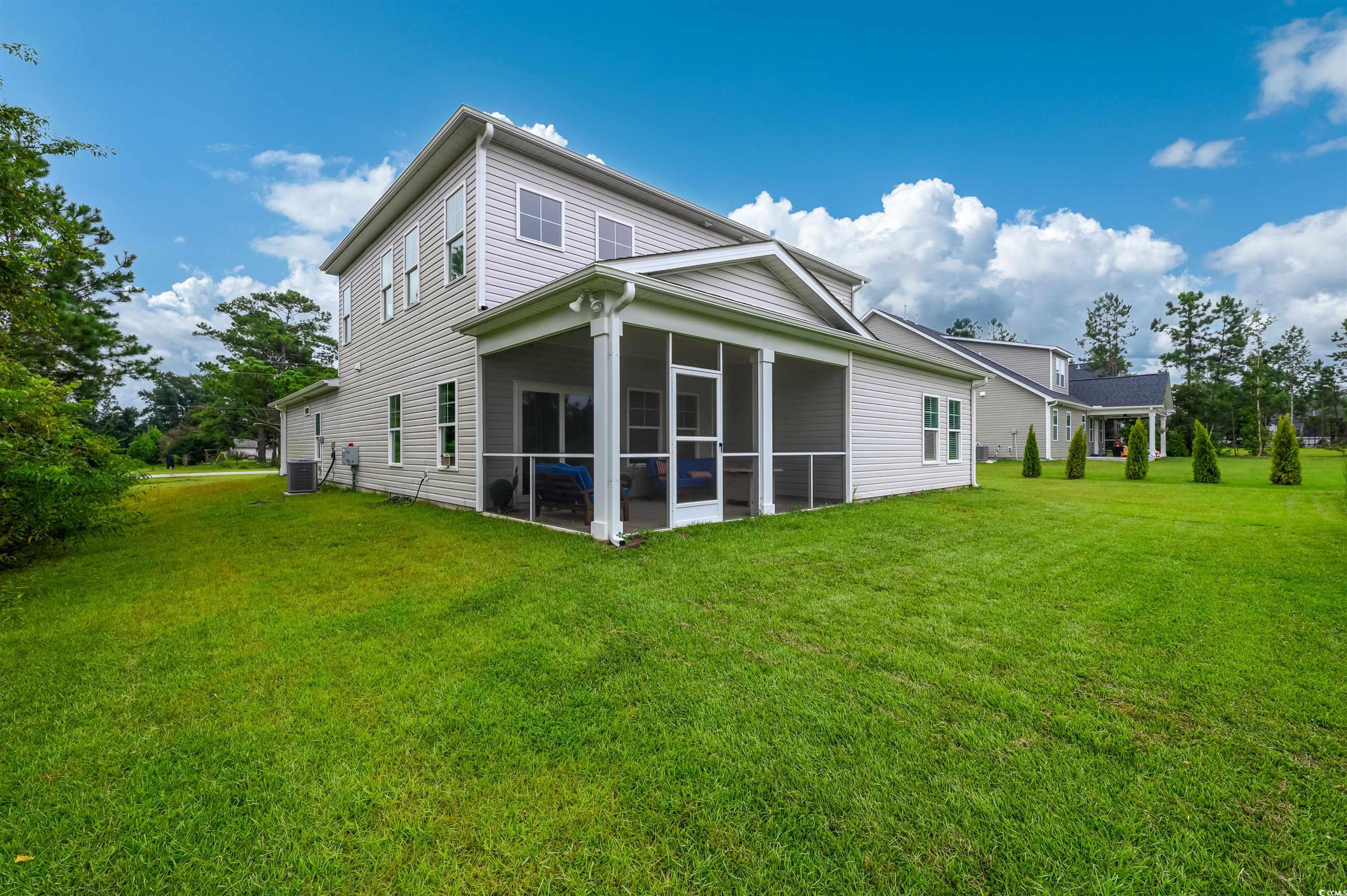 2550 Dogwood Road Longs, SC 29568 - Photo 30 of 35 Rear view of house featuring a yard and a sunroom
