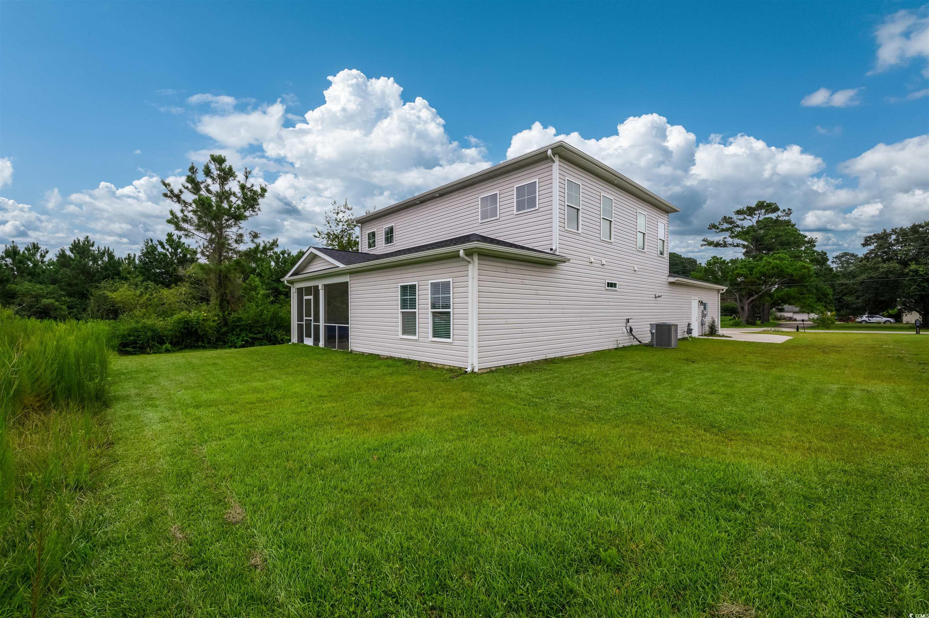 2550 Dogwood Road Longs, SC 29568 - Photo 31 of 35 View of home's exterior featuring a yard and a sunroom