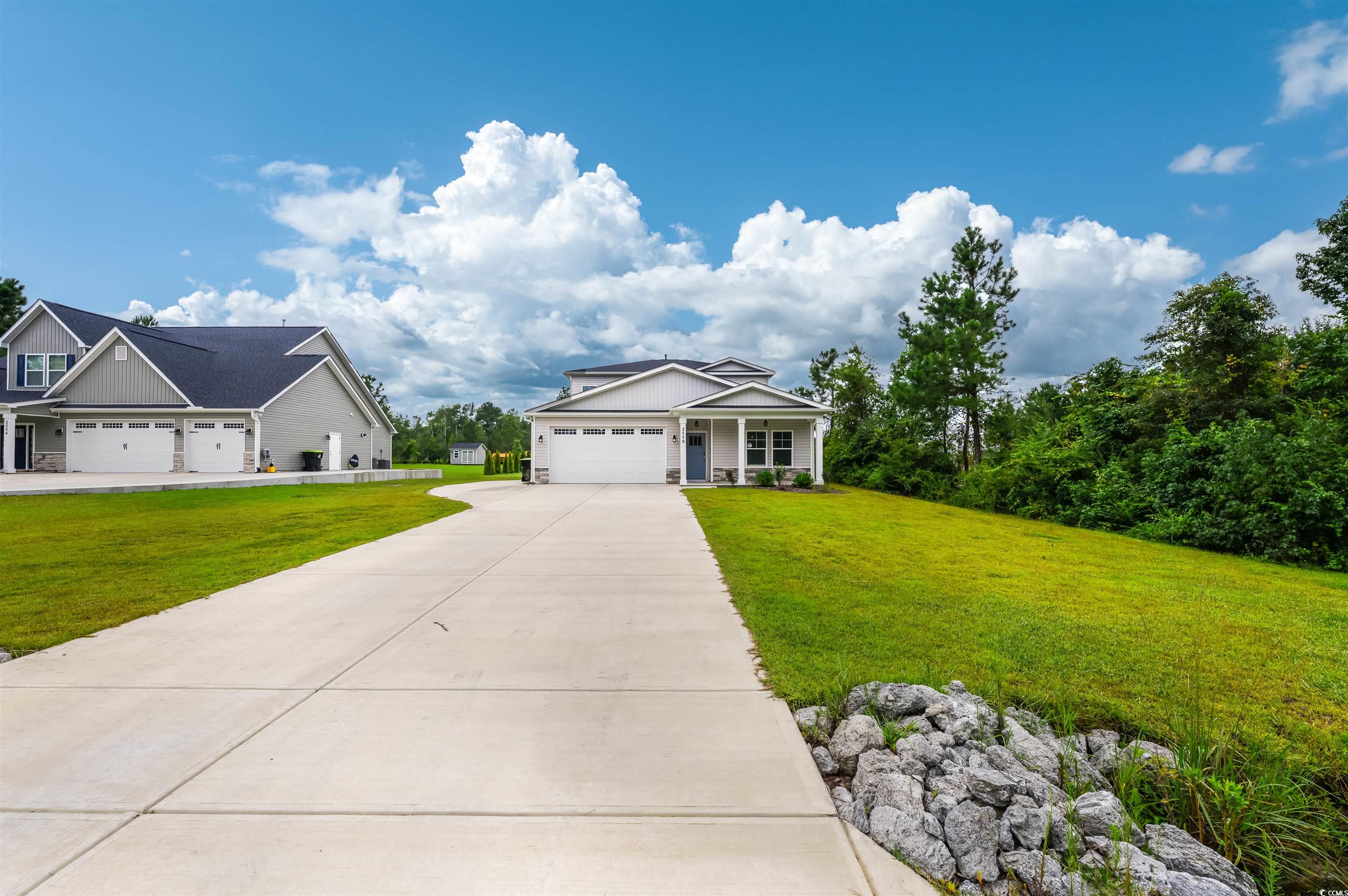 2550 Dogwood Road Longs, SC 29568 - Photo 33 of 35 Craftsman-style home featuring a front yard, concrete driveway, an attached garage, and a porch