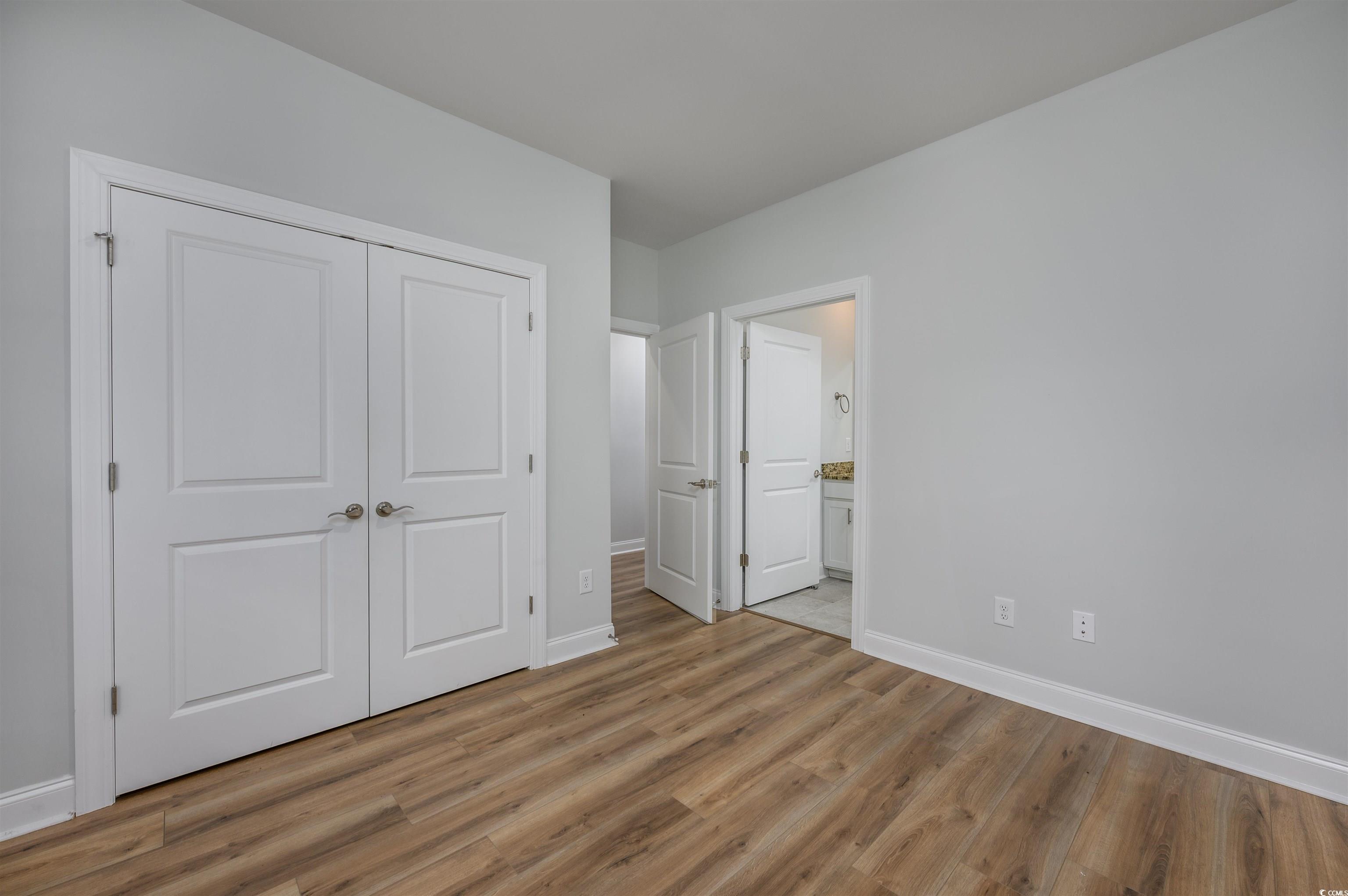 2550 Dogwood Road Longs, SC 29568 - Photo 8 of 35 Unfurnished bedroom with wood finished floors, a closet, and connected bathroom