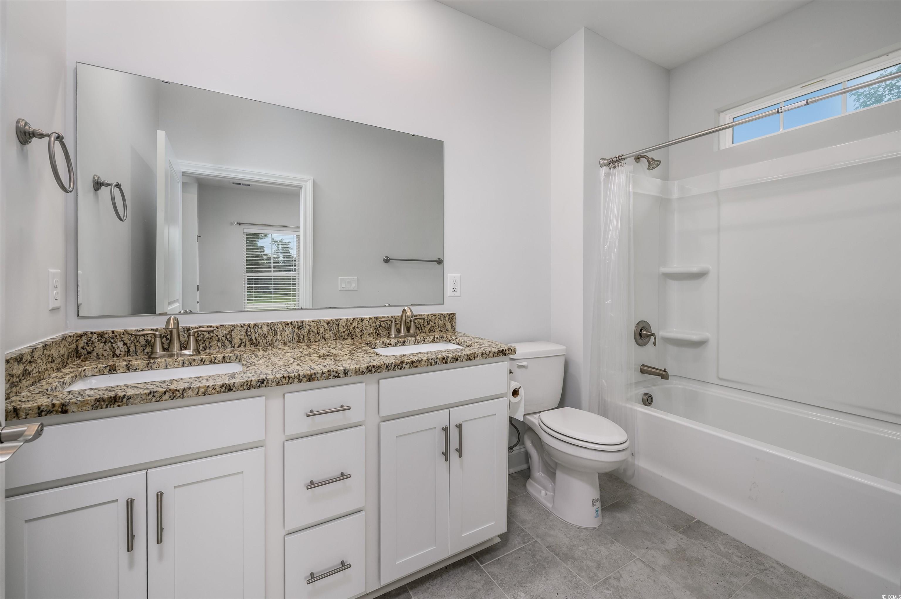 2550 Dogwood Road Longs, SC 29568 - Photo 10 of 35 Full bathroom with shower / bath combo, double vanity, and light tile patterned flooring