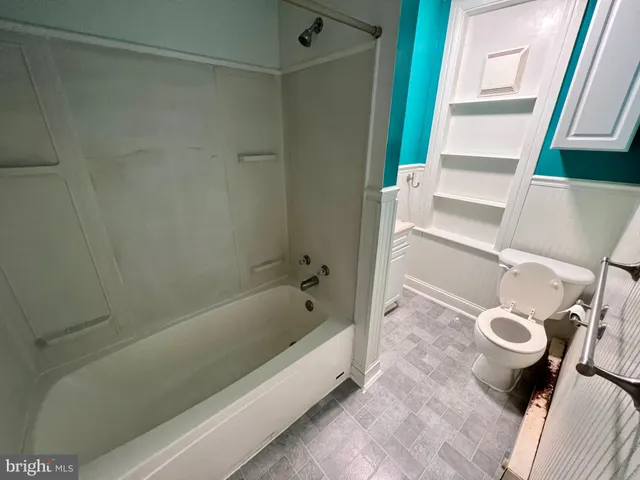 a bathroom with a tub and a shower