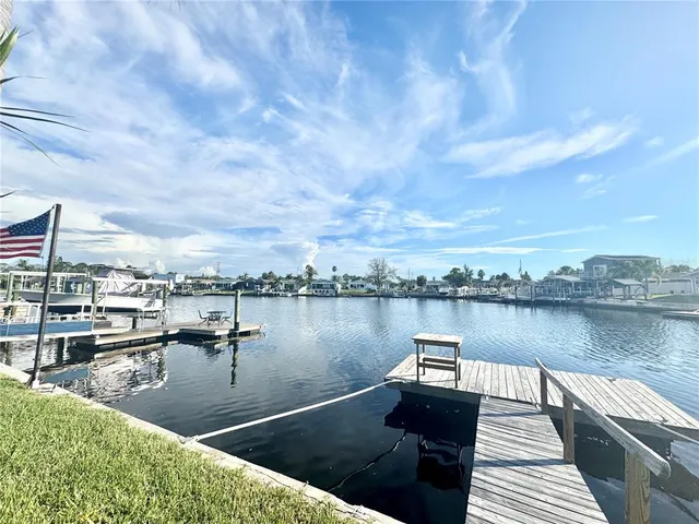 a view of a house with a big yard and potted plants