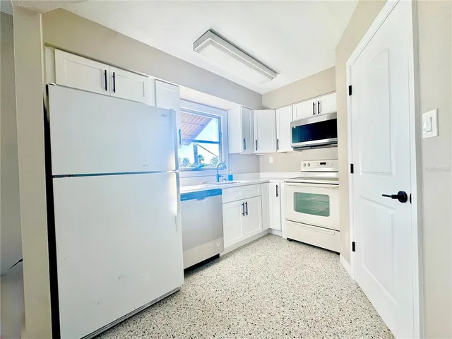a white refrigerator freezer sitting in a kitchen