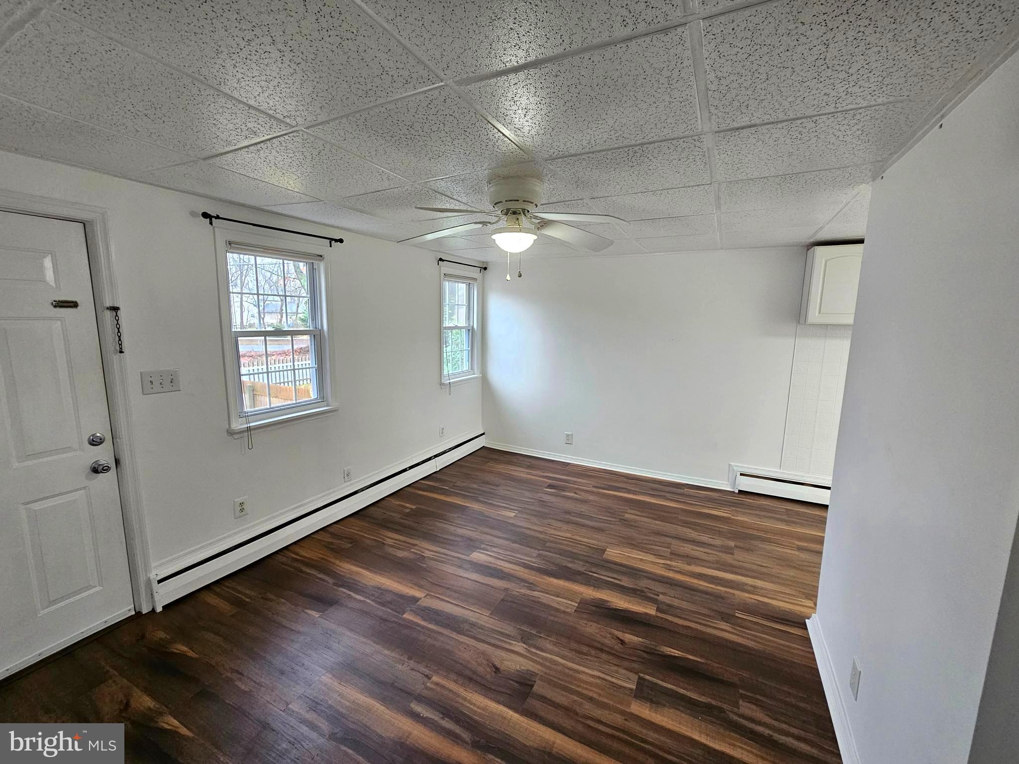 506 Rancocas Avenue Hainesport, NJ 08036 - Photo 3 of 22 a view of an empty room with wooden floor and a window