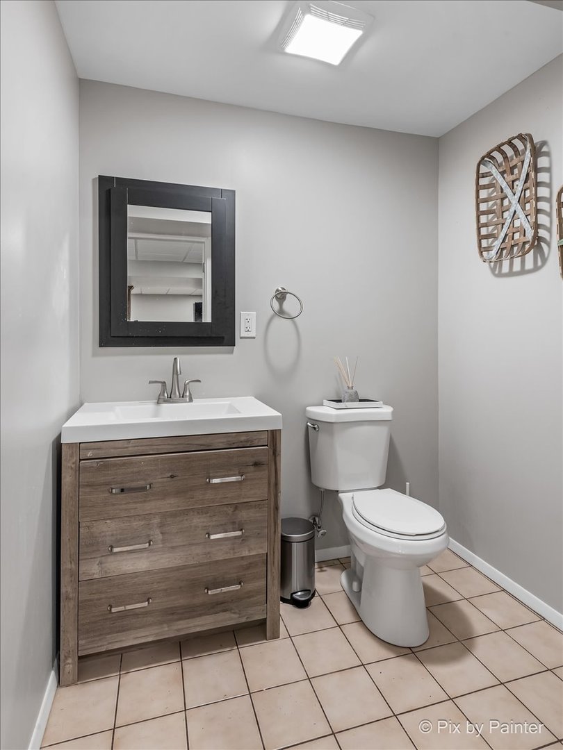 2628 Knob Hill Road Johnsburg, IL 60051 - Photo 39 of 43 a bathroom with a toilet sink and mirror