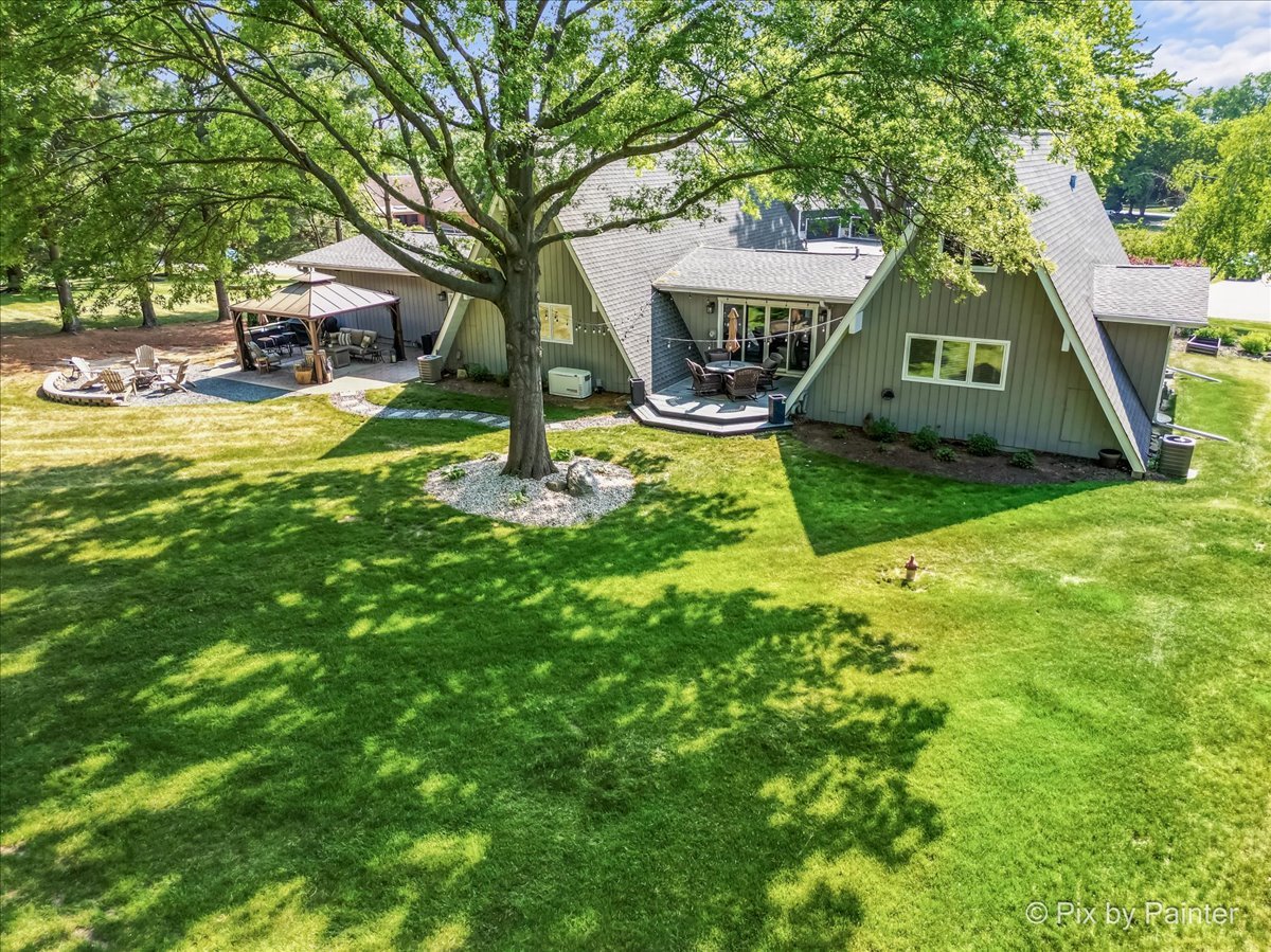 2628 Knob Hill Road Johnsburg, IL 60051 - Photo 9 of 43 a view of an house with backyard and tree
