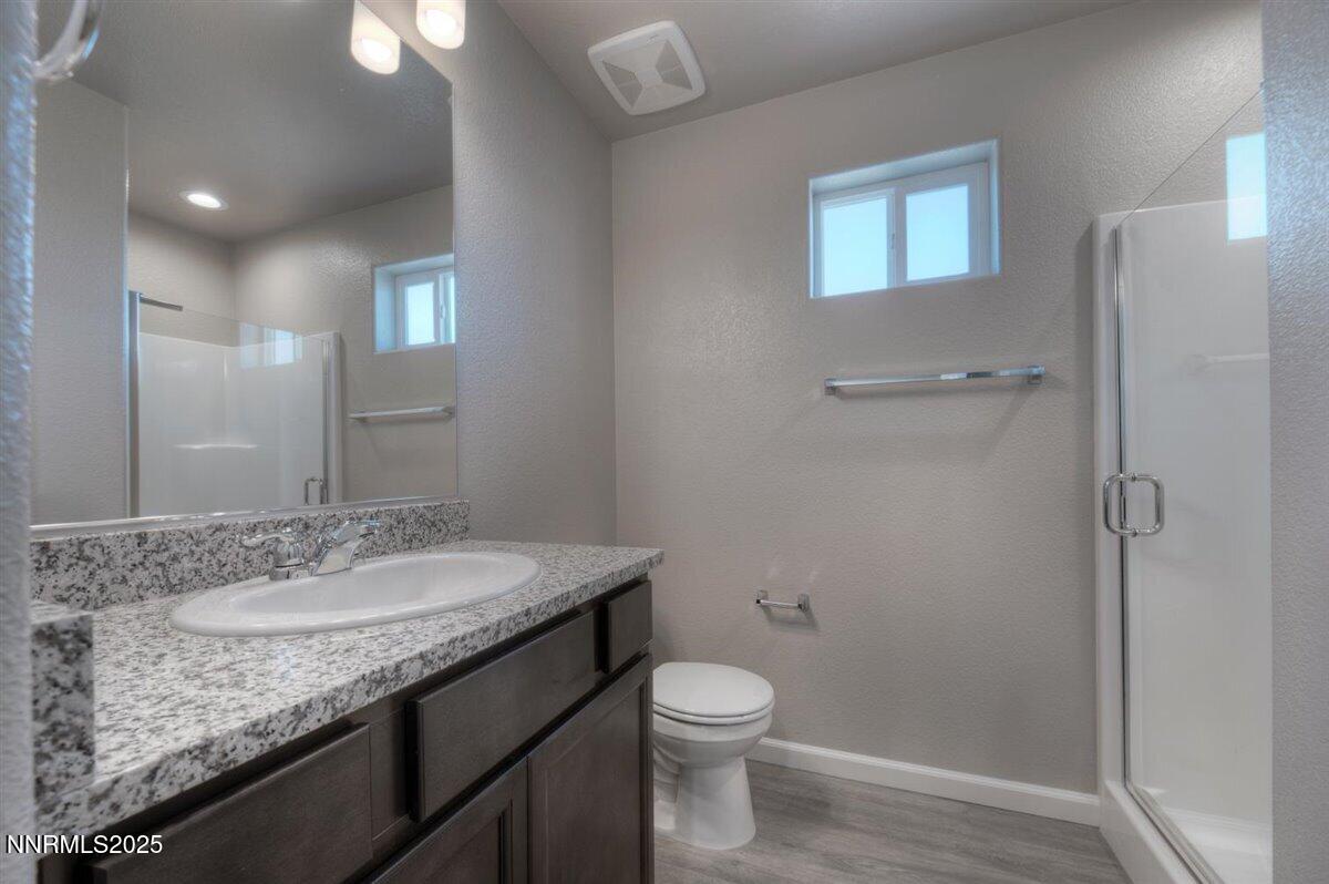 1168 Arrastra Road, Unit LOT 18 Reno, NV 89512 - Photo 21 of 24 a bathroom with a granite countertop sink toilet and shower
