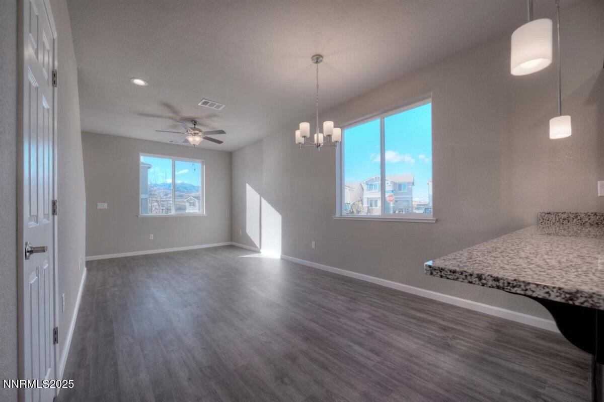 1168 Arrastra Road, Unit LOT 18 Reno, NV 89512 - Photo 6 of 24 an empty room with wooden floor and windows