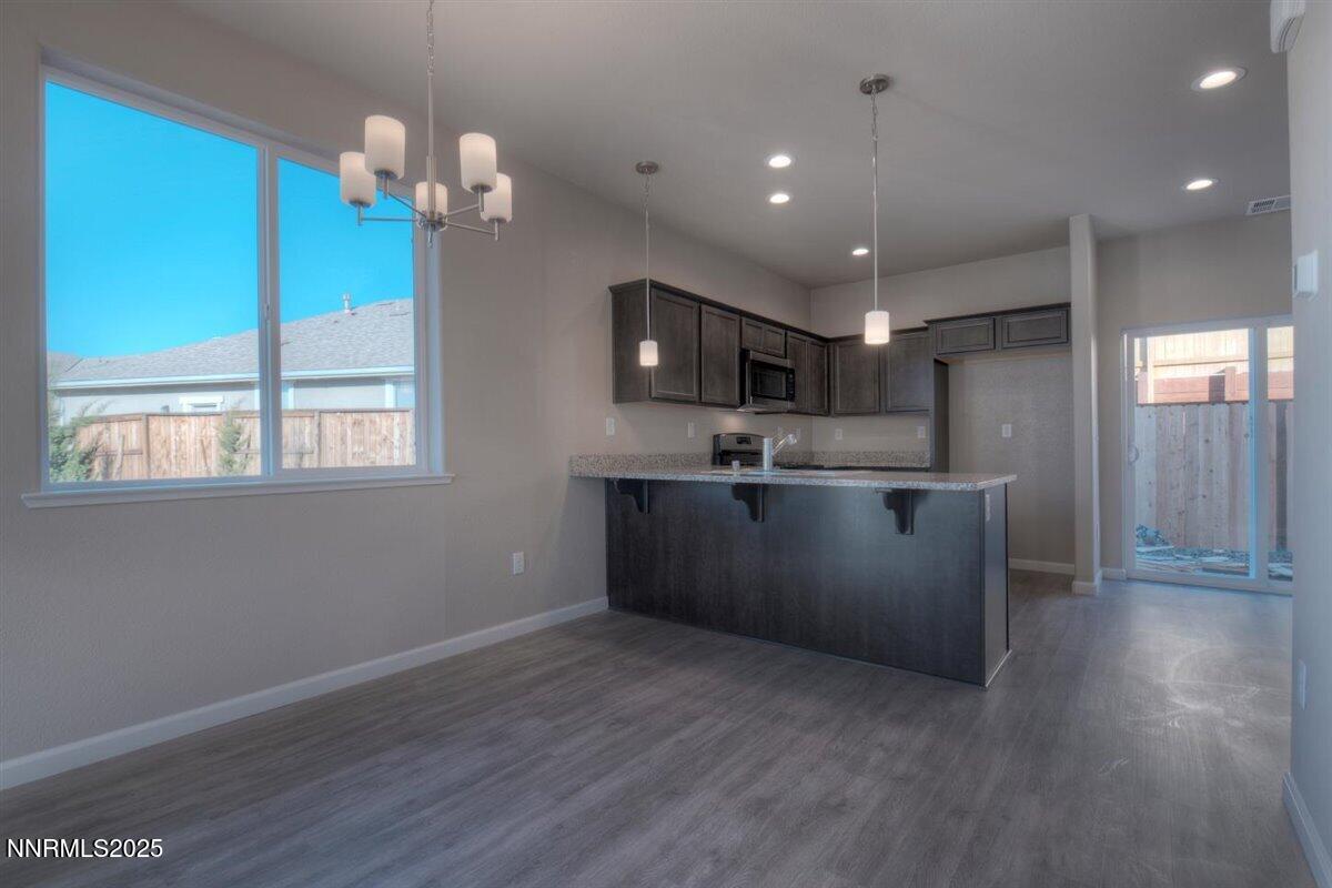 1168 Arrastra Road, Unit LOT 18 Reno, NV 89512 - Photo 7 of 24 a kitchen with kitchen island white cabinets and stainless steel appliances