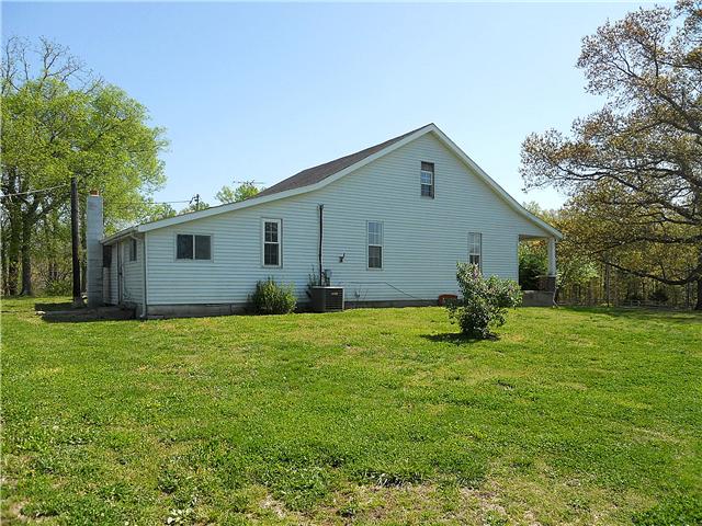 10515 Moss Branch Road Bon Aqua, TN 37025 - Photo 17 of 20 Side of house- the back porch has been enclosed for a mud room/storage area/ plant room.