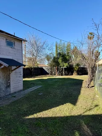 a view of a backyard with large trees