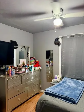 a room with a chandelier furniture and a flat screen tv