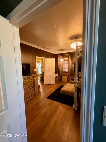 a bedroom with furniture and a large window