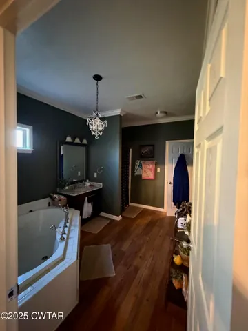 a living room with furniture a chandelier and a fireplace