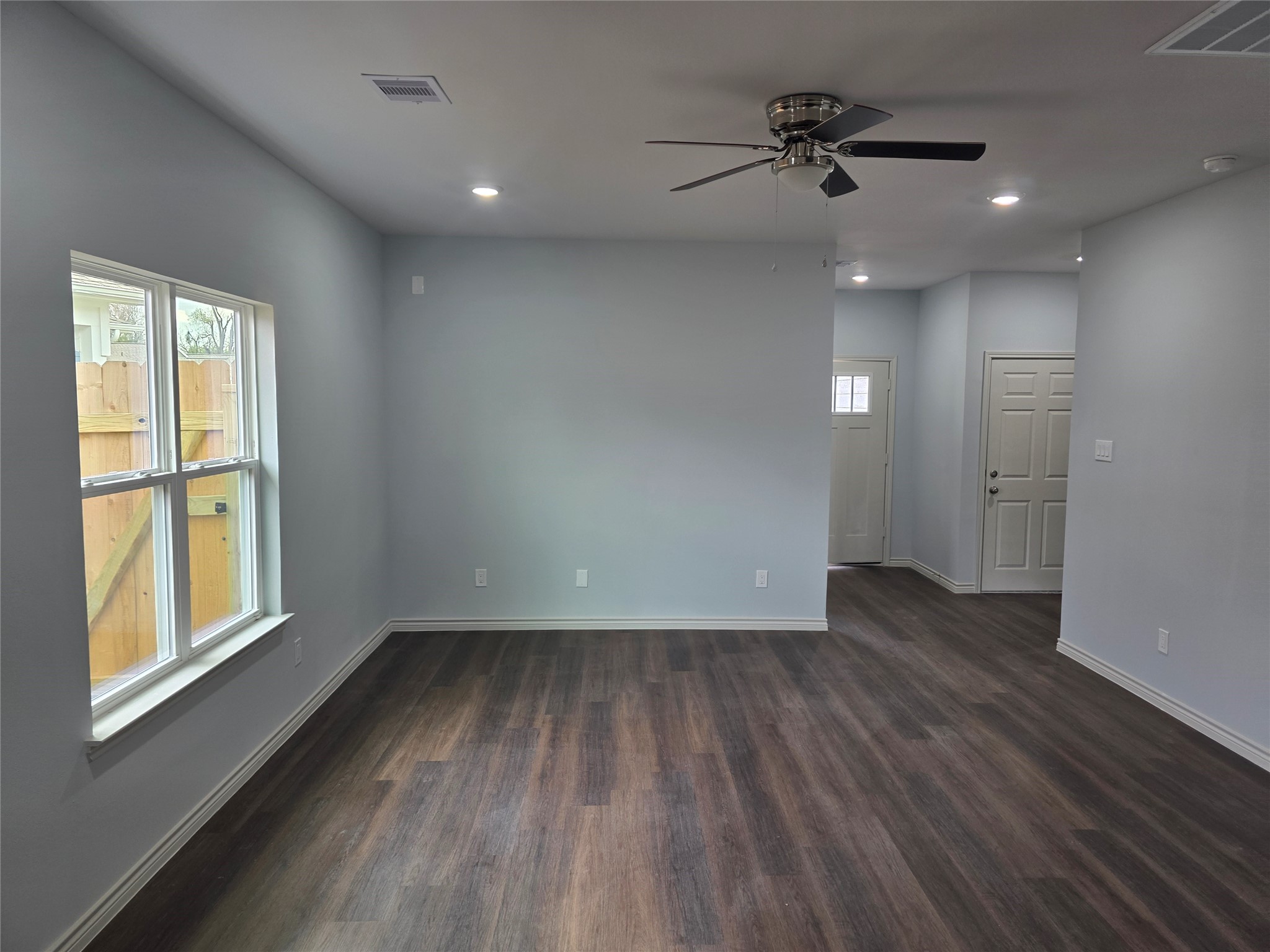 213 Dipping Stream Street Houston, TX 77076 - Photo 2 of 10 wooden floor in an empty room with a window