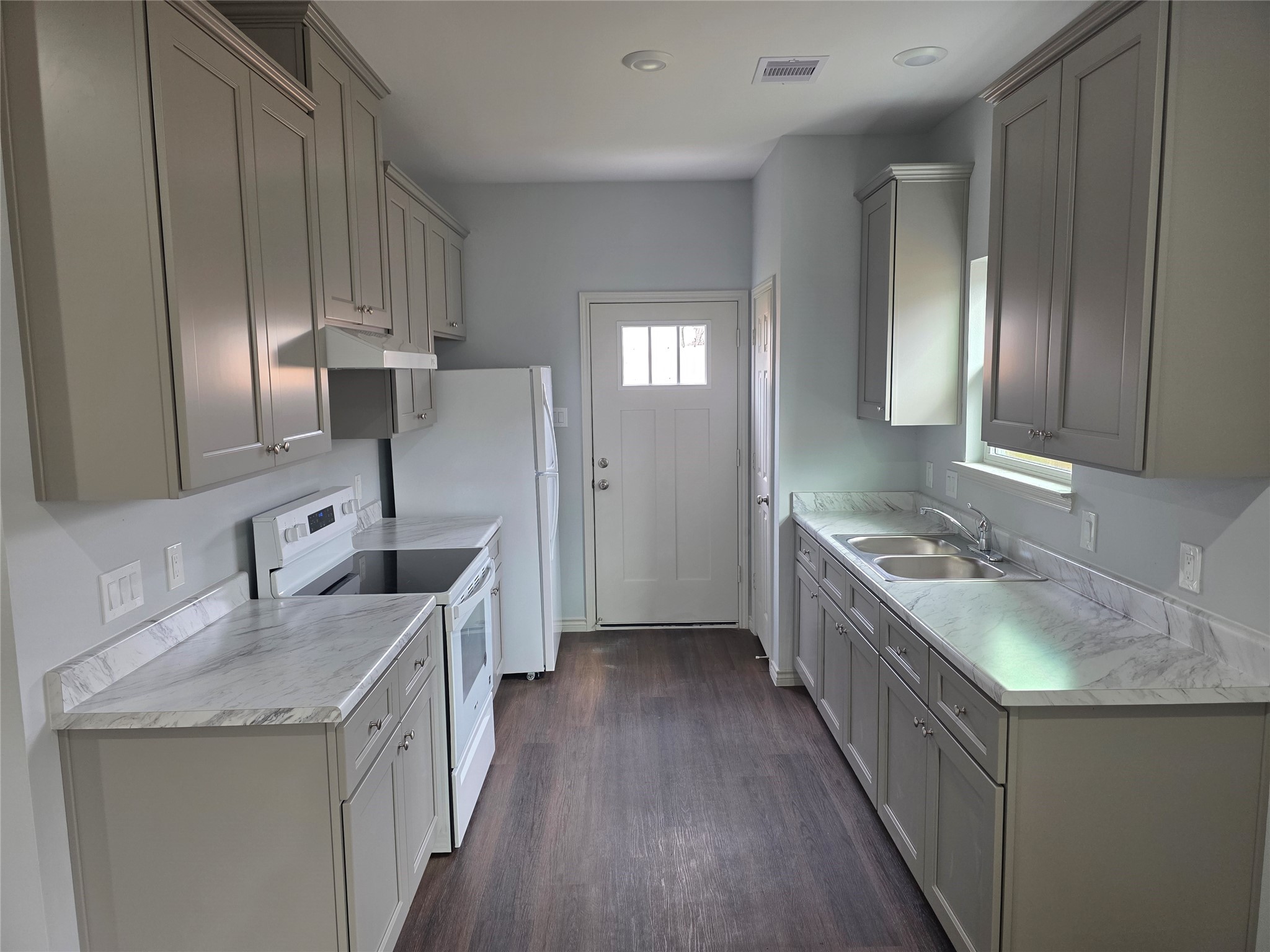 213 Dipping Stream Street Houston, TX 77076 - Photo 3 of 10 a kitchen with stainless steel appliances granite countertop a sink stove and cabinets