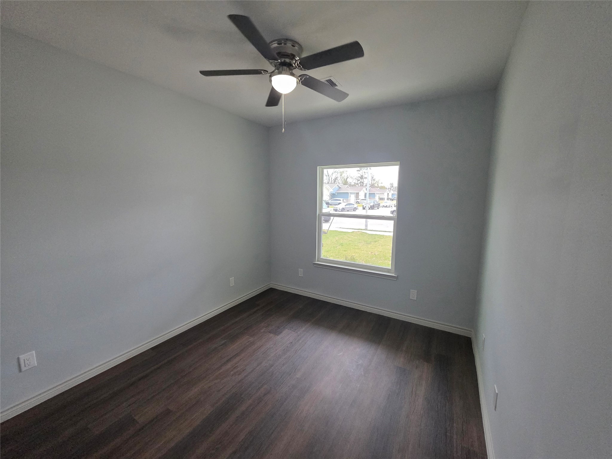 213 Dipping Stream Street Houston, TX 77076 - Photo 5 of 10 an empty room with wooden floor and windows