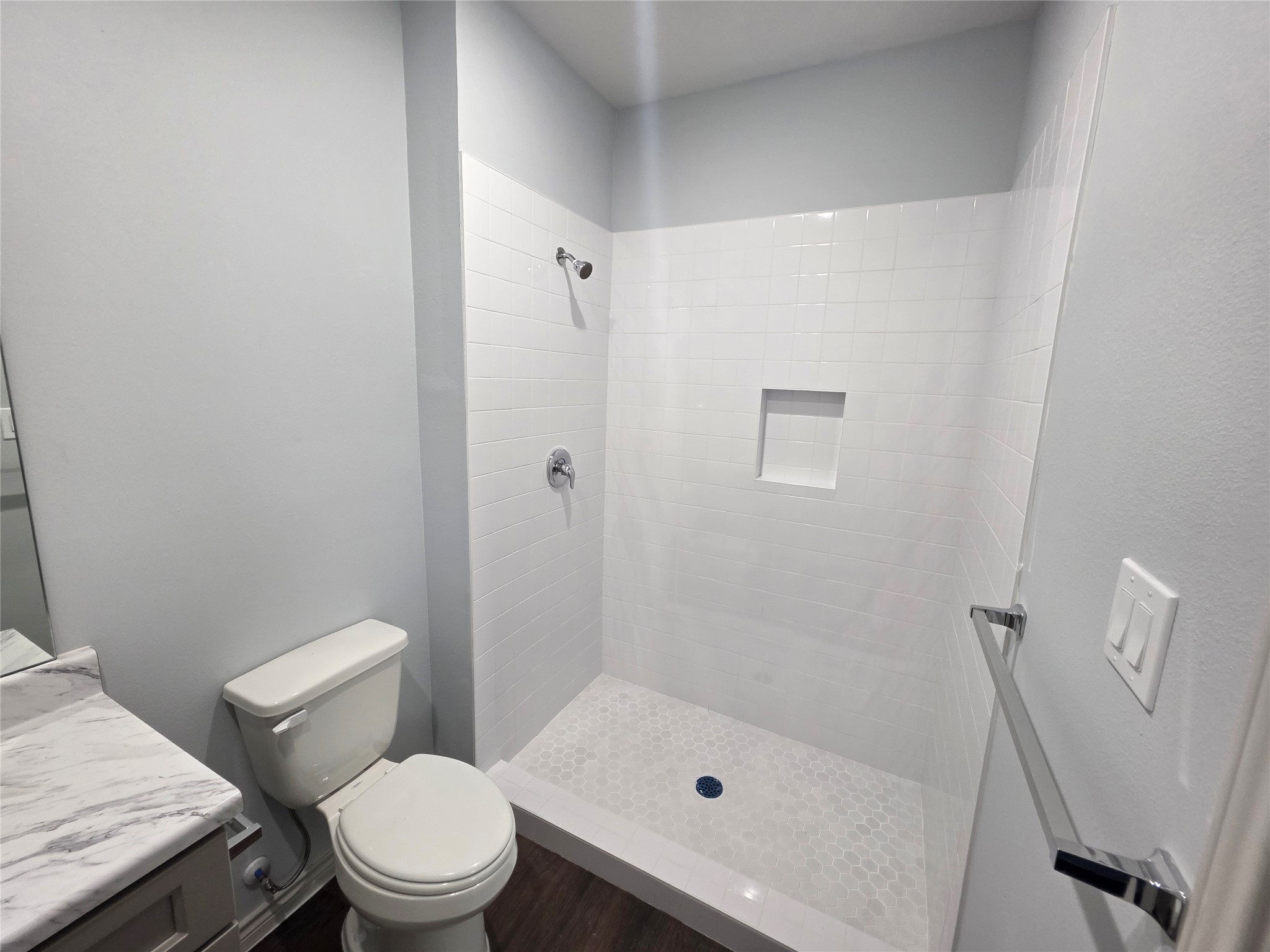 213 Dipping Stream Street Houston, TX 77076 - Photo 7 of 10 a white toilet sitting next to a bath tub