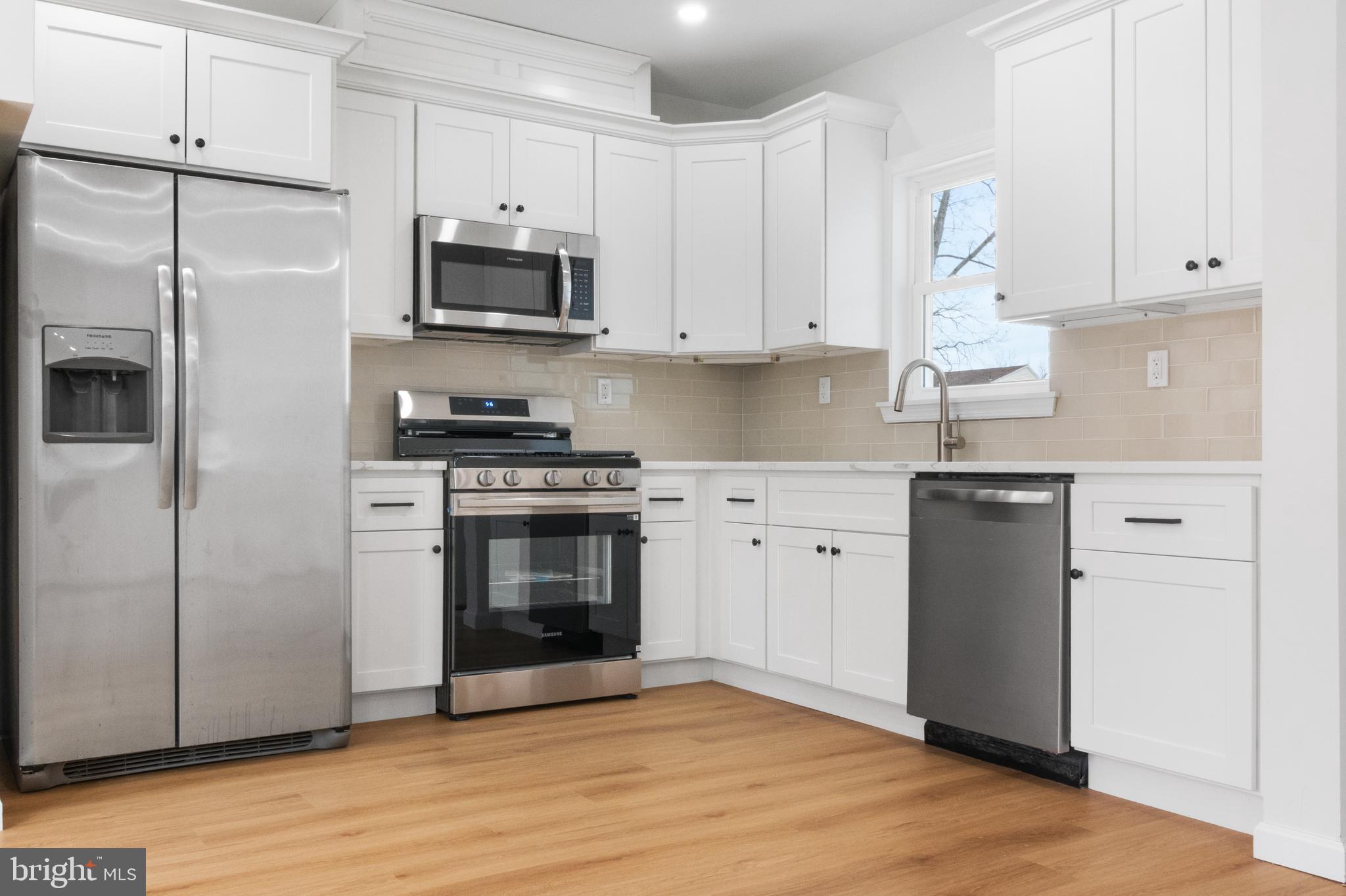 119 Hemlock Avenue Laurel Springs, NJ 08021 - Photo 11 of 23 a kitchen with cabinets stainless steel appliances and wooden floor
