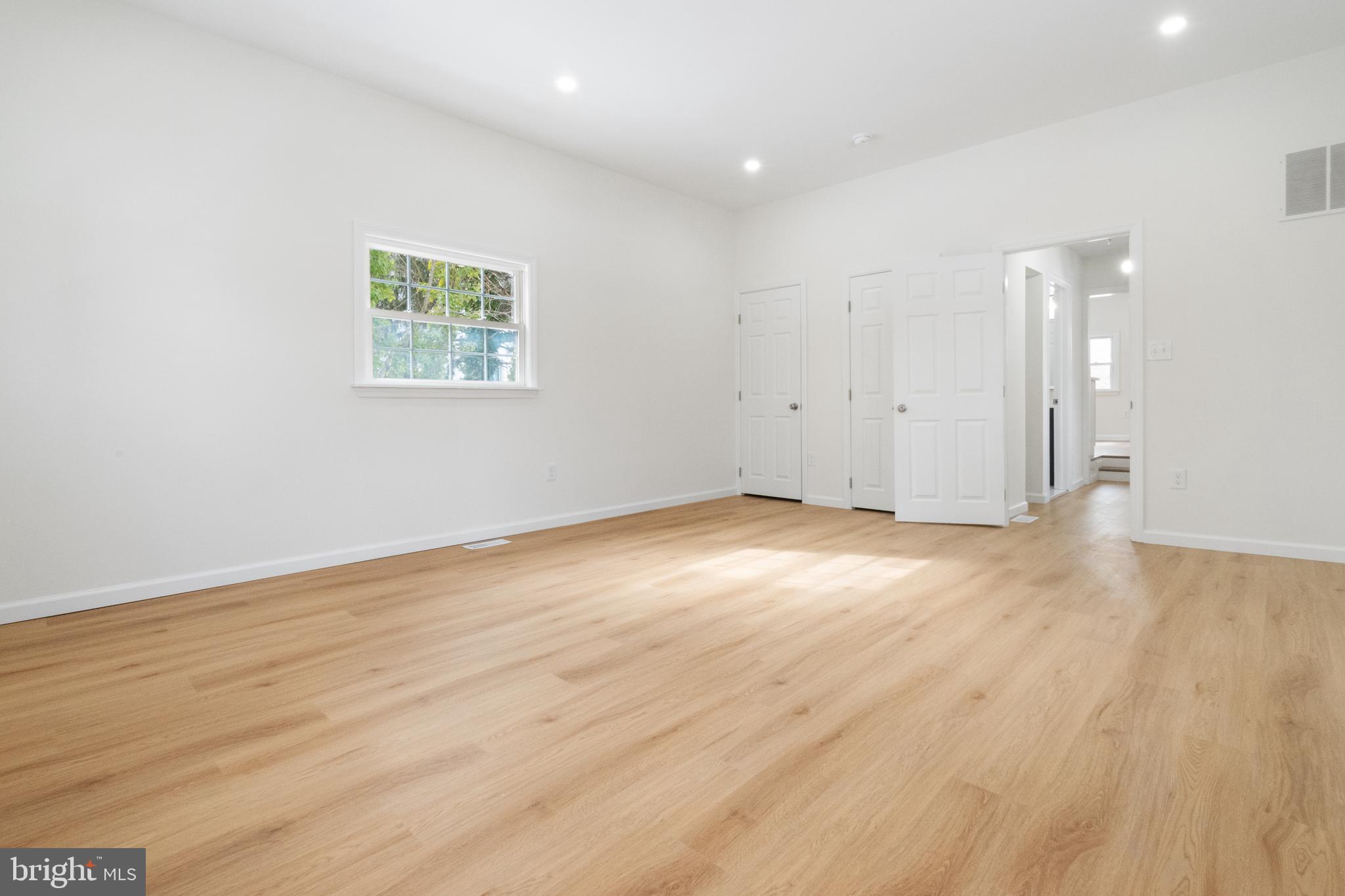 119 Hemlock Avenue Laurel Springs, NJ 08021 - Photo 16 of 23 an empty room with wooden floor and windows