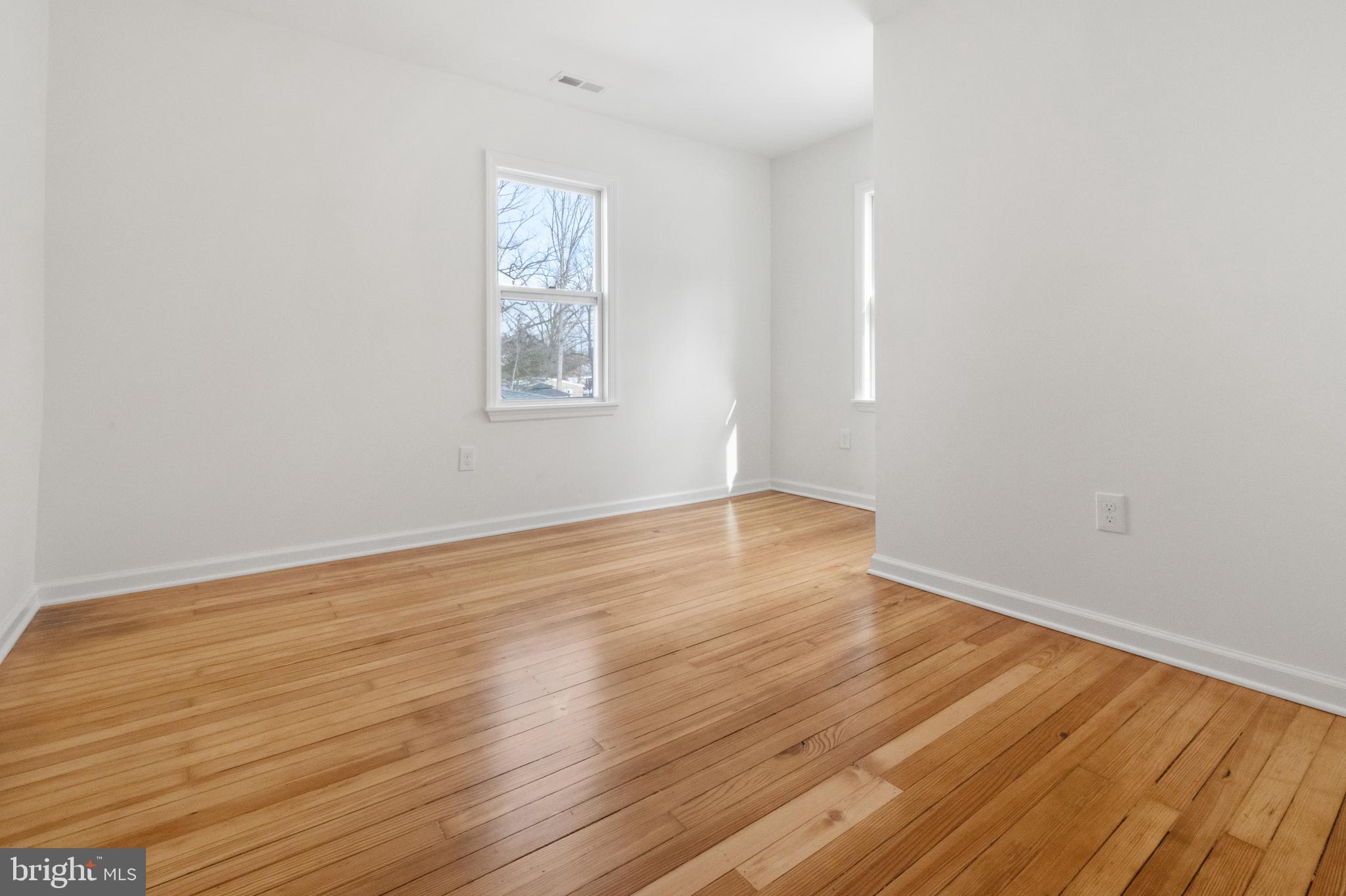 119 Hemlock Avenue Laurel Springs, NJ 08021 - Photo 18 of 23 an empty room with wooden floor and windows