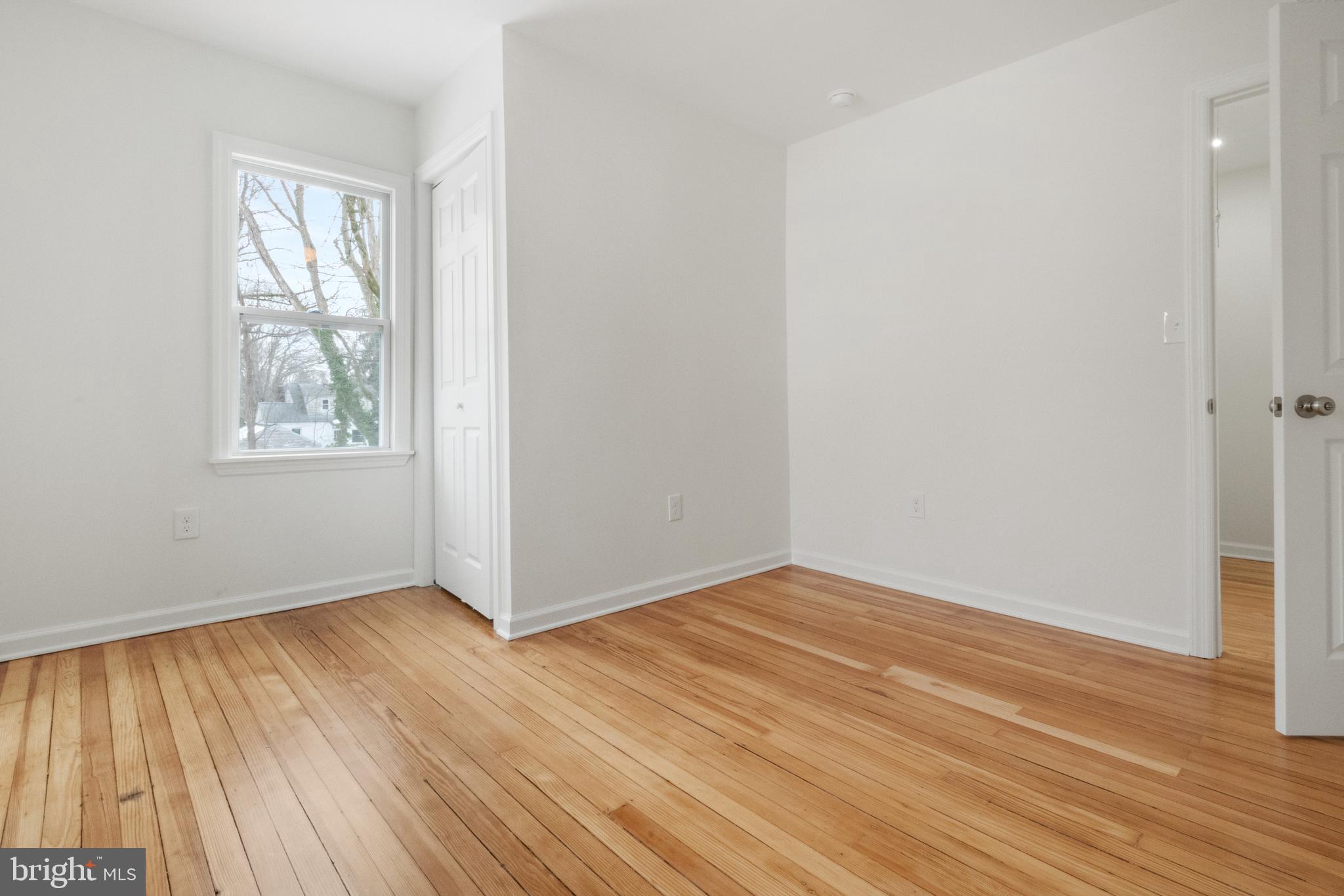 119 Hemlock Avenue Laurel Springs, NJ 08021 - Photo 20 of 23 an empty room with wooden floor and windows