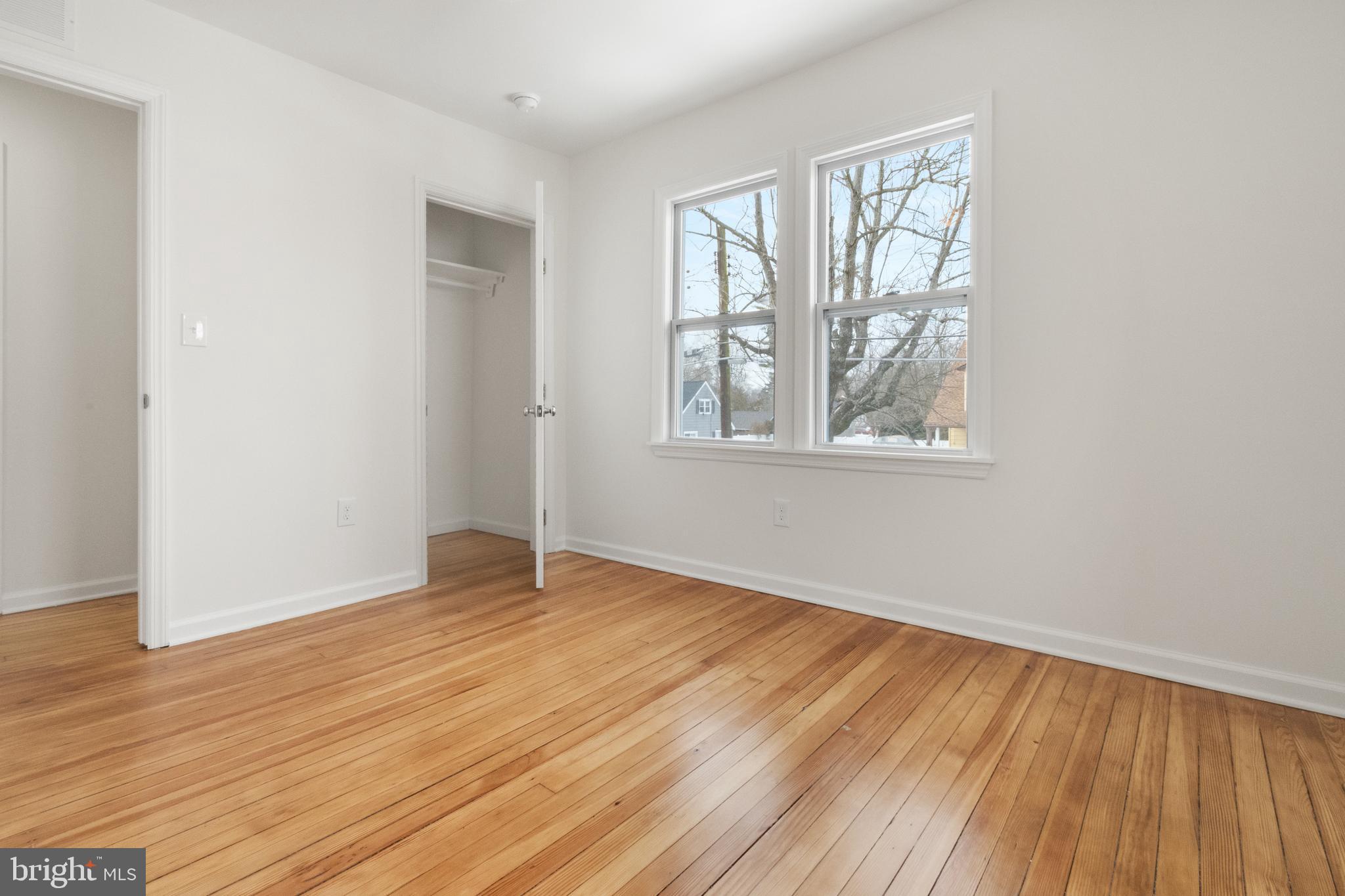119 Hemlock Avenue Laurel Springs, NJ 08021 - Photo 21 of 23 an empty room with wooden floor and windows