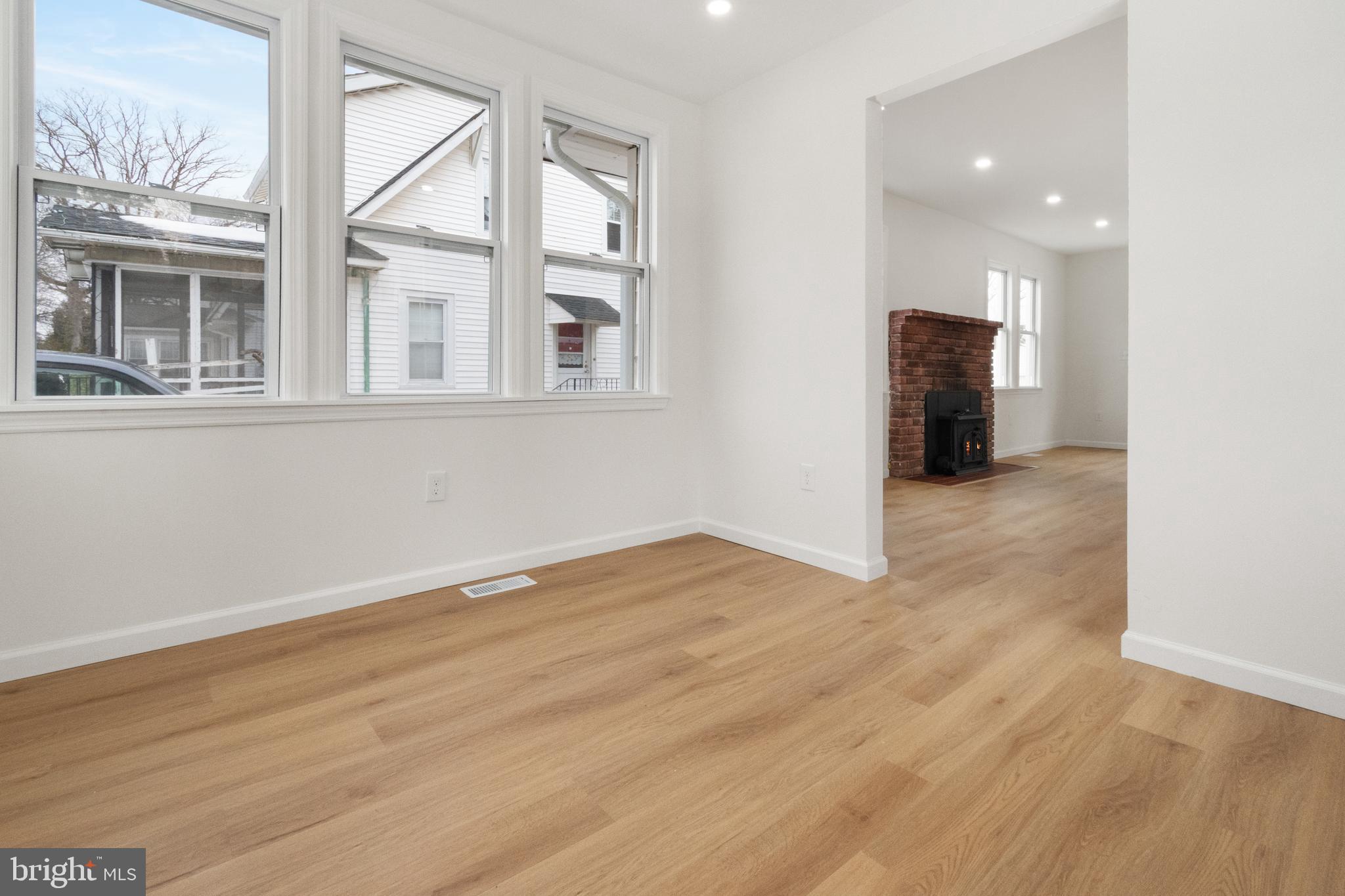 119 Hemlock Avenue Laurel Springs, NJ 08021 - Photo 5 of 23 an empty room with wooden floor and windows
