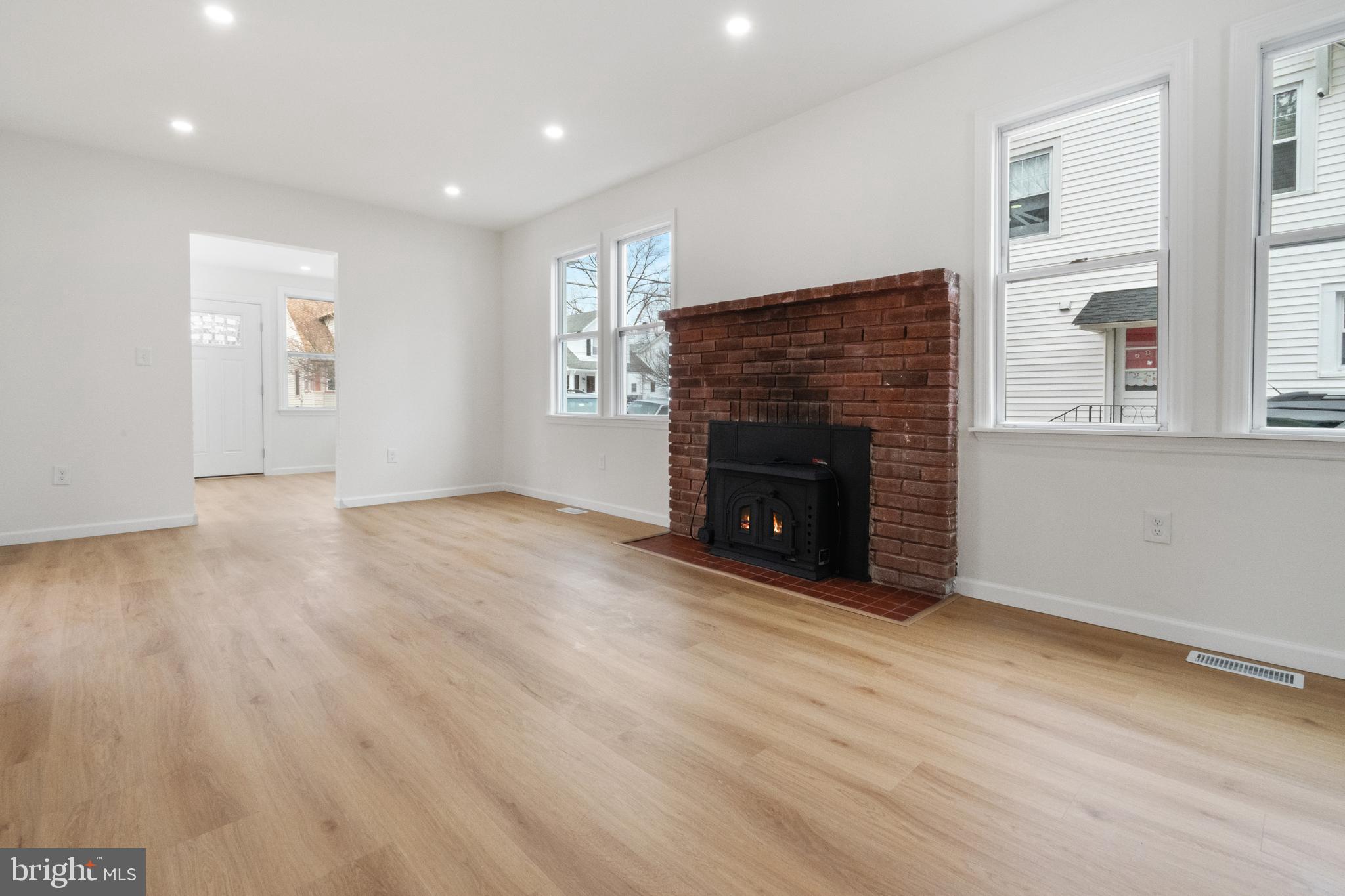 119 Hemlock Avenue Laurel Springs, NJ 08021 - Photo 7 of 23 an empty room with windows and fireplace