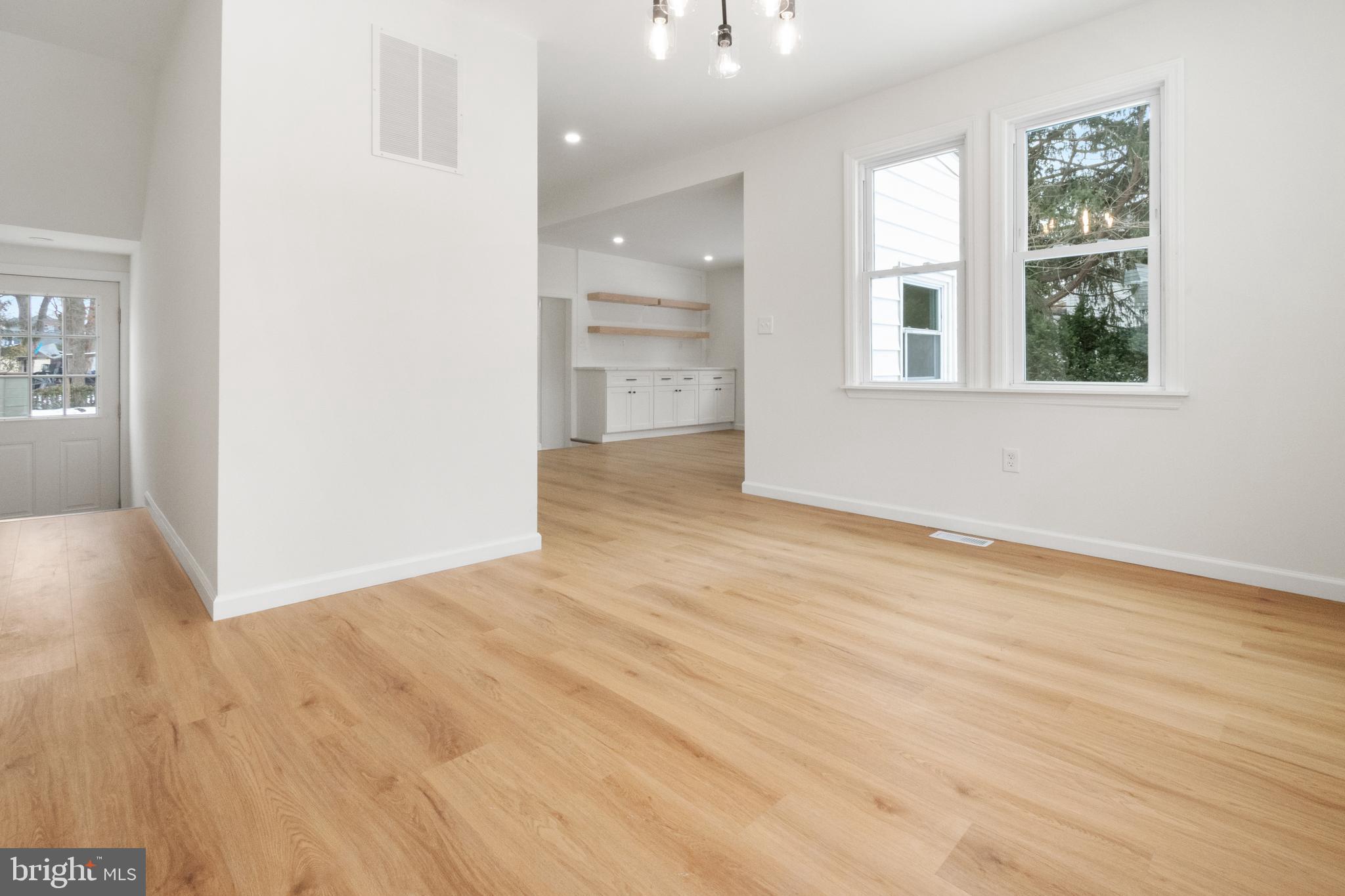 119 Hemlock Avenue Laurel Springs, NJ 08021 - Photo 9 of 23 an empty room with wooden floor and windows