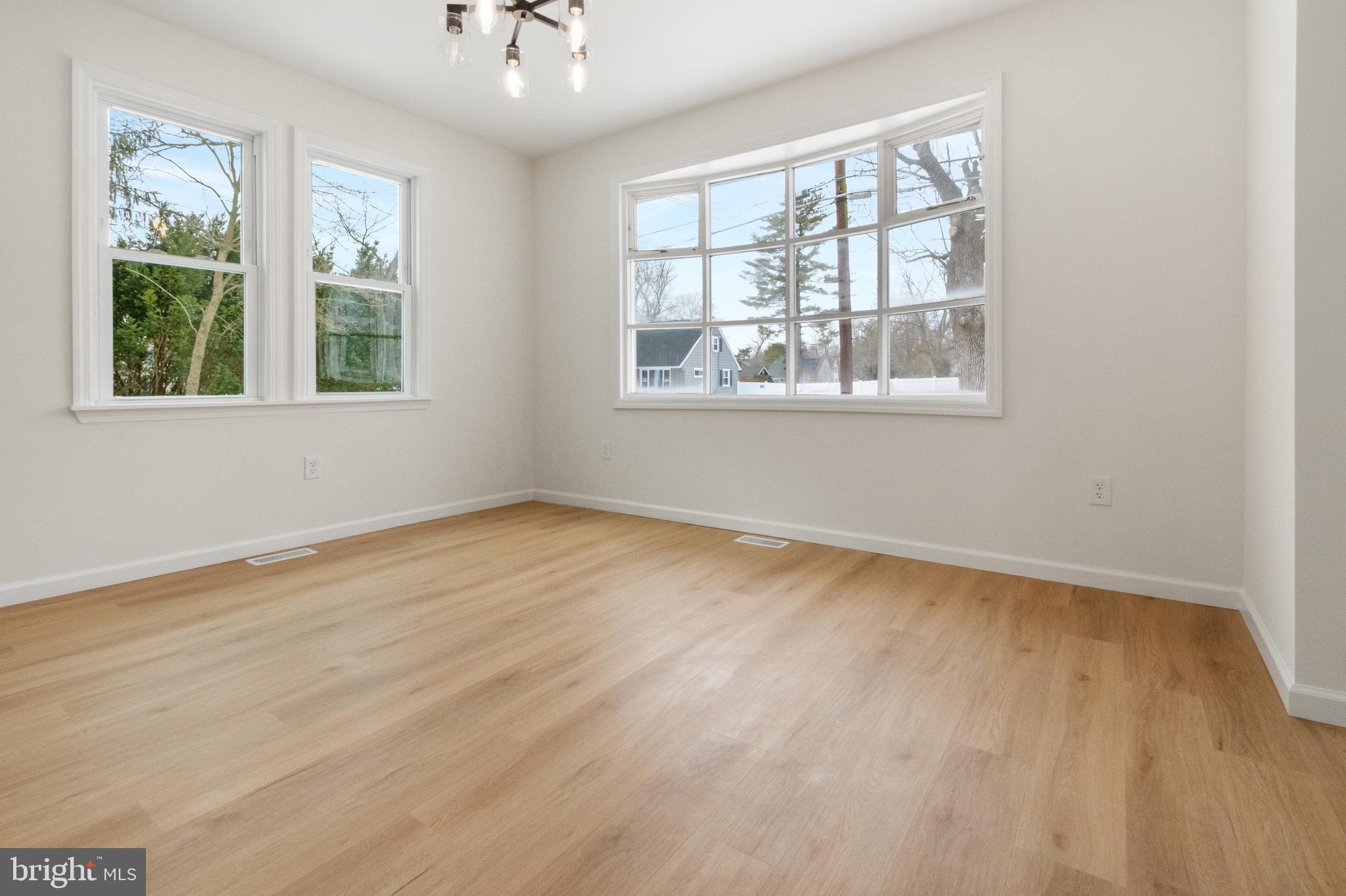119 Hemlock Avenue Laurel Springs, NJ 08021 - Photo 10 of 23 a view of an empty room with wooden floor and a window