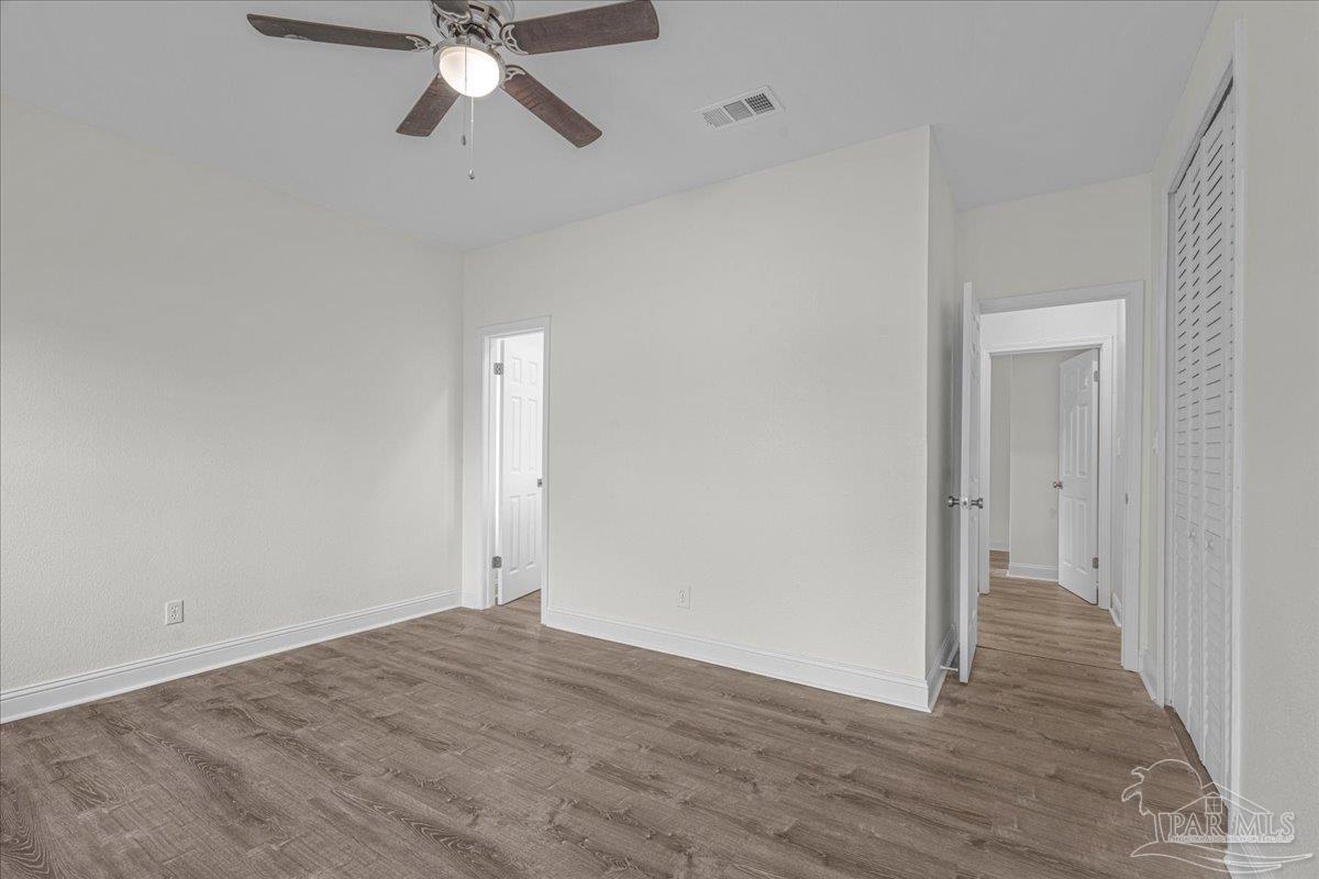601 East Burgess Road, Unit C3 Pensacola, FL 32504 - Photo 26 of 35 a view of empty room with wooden floor and ceiling fan